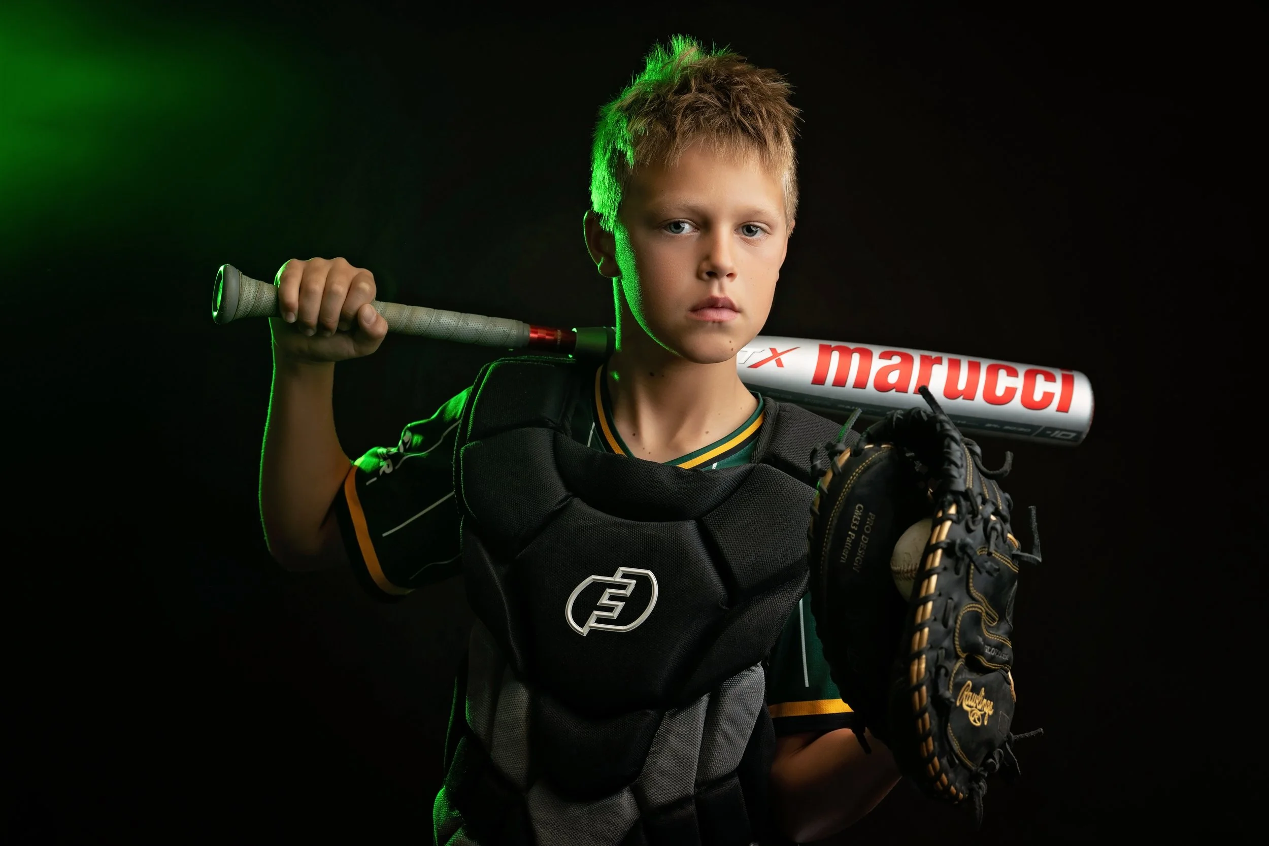 A young baseball player poses with his gear during his Beyond the Game session