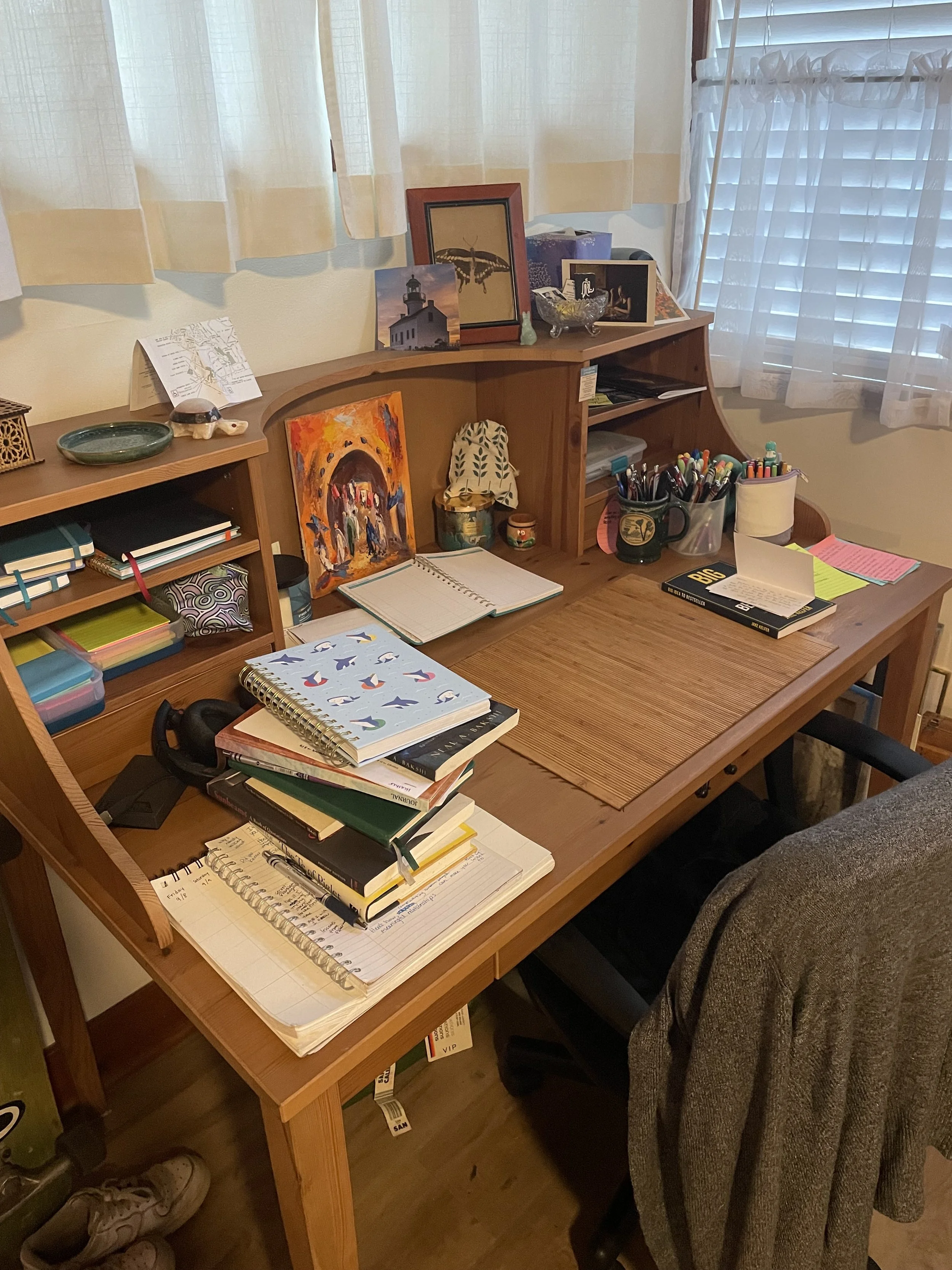 My desk. Featuring my 20 thousand notebooks. And what's that up top?