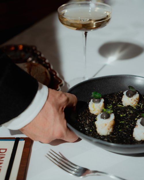 A dish being served at the table
