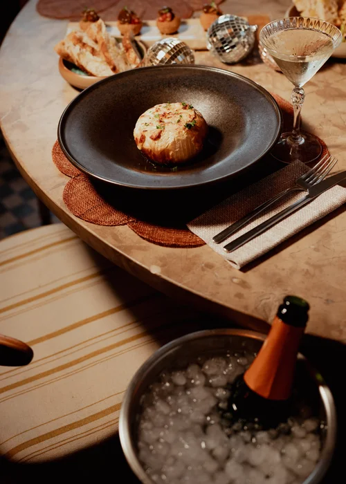 A dish with a bottle of Champagne on ice