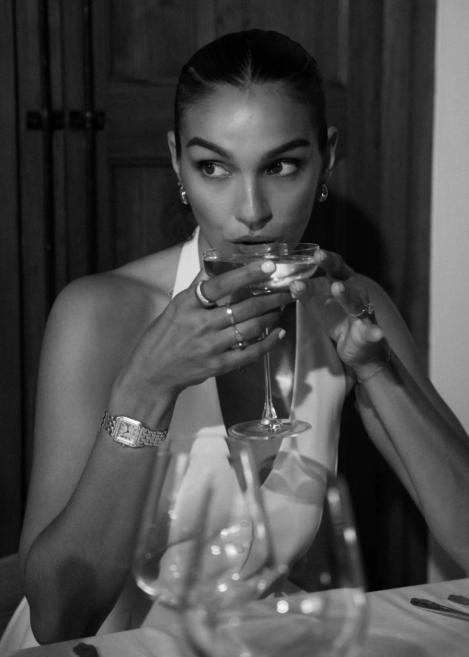 Guest at the bar of Chez Junior S&oacute;ller holding a coupe glass