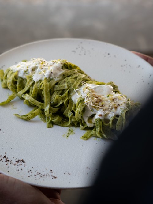 Green pasta with fresh cheese
