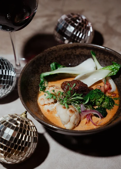 Fish in a bowl of broth with herbs