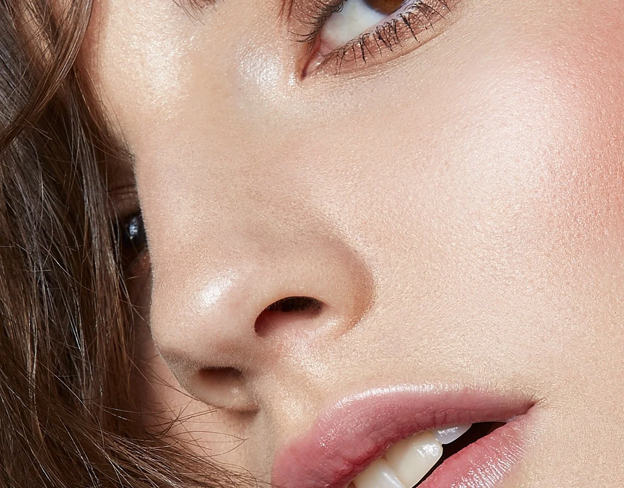 Close-up beauty portrait of the eye, nose, and lips, with natural makeup, photography by Justin Munitz.