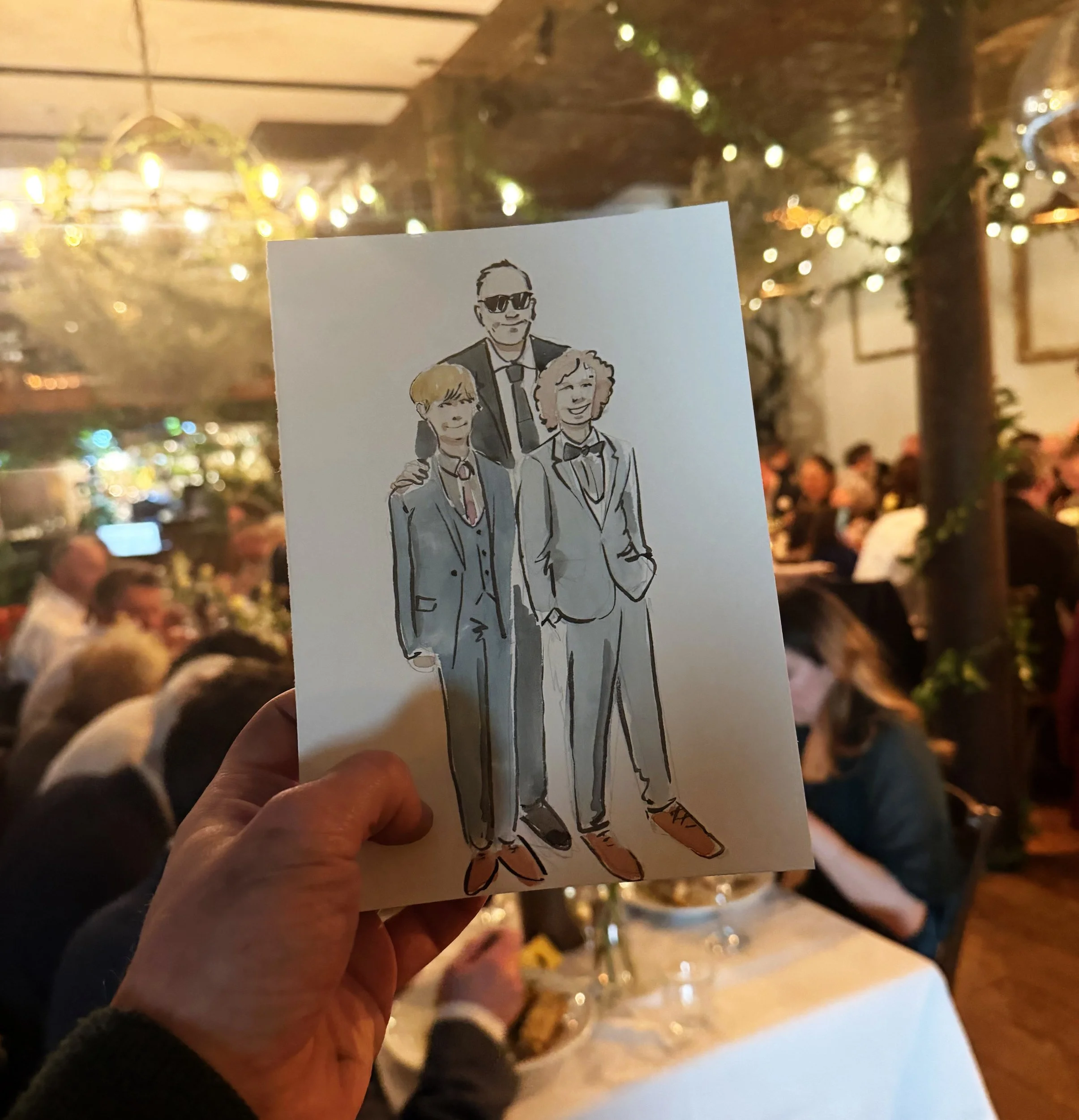 Colorful illustration of three people dressed in suits, with the person in the middle wearing sunglasses, at a festive event with warm lighting and blurred crowd background.