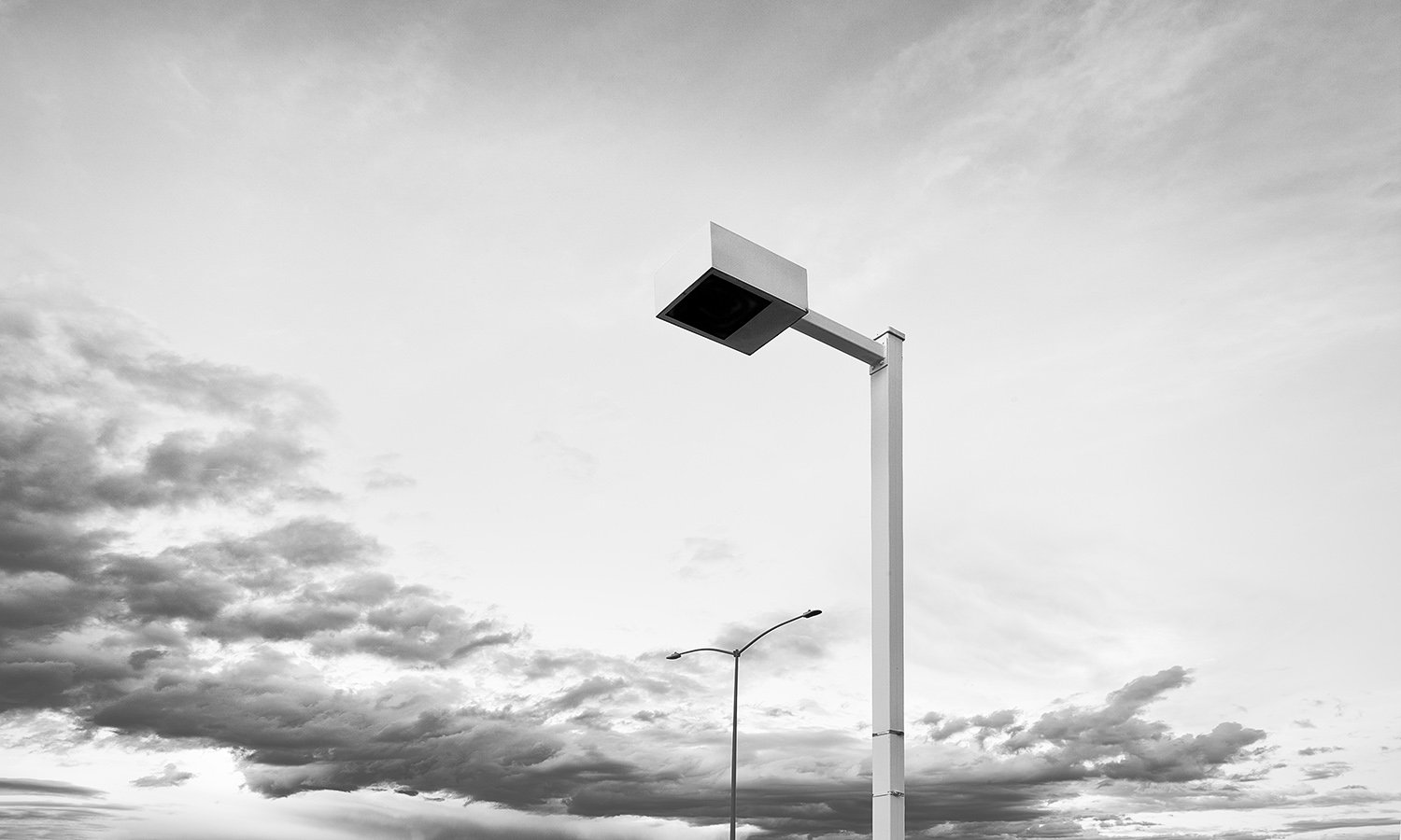 Two Light Poles, Sweeping Clouds
