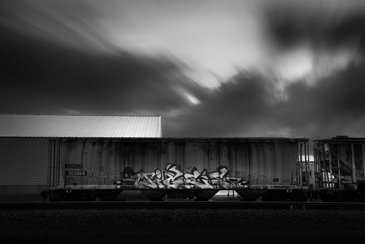 Rail Car, Graffiti, and Clouds