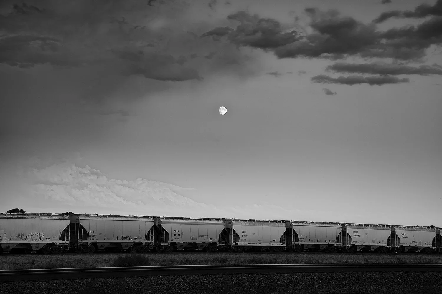 Seven Hopper Cars, Moon, and Clouds