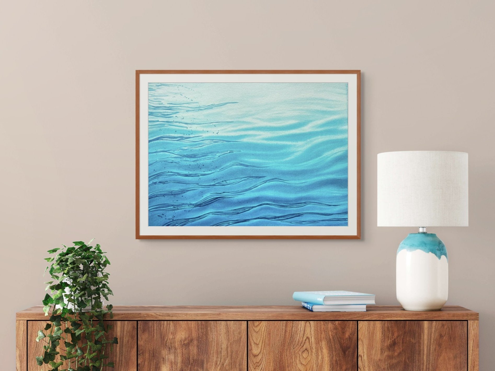 Original watercolor painting "Still Waters" framed and staged in a living room or hallway, adding a calming, serene touch with its gentle wave patterns.