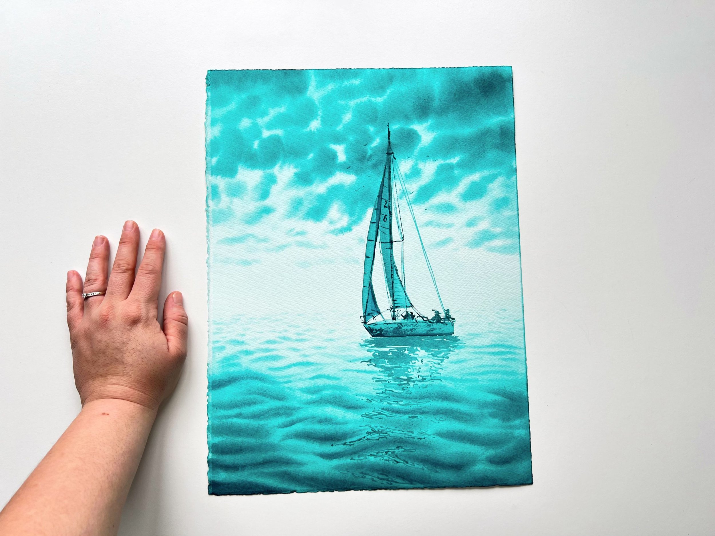 Closeup of a monochromatic turquoise watercolor of a sailing yacht in the open sea. "Turquoise Green" evokes adventure and freedom with dynamic brushstrokes and vibrant hues.