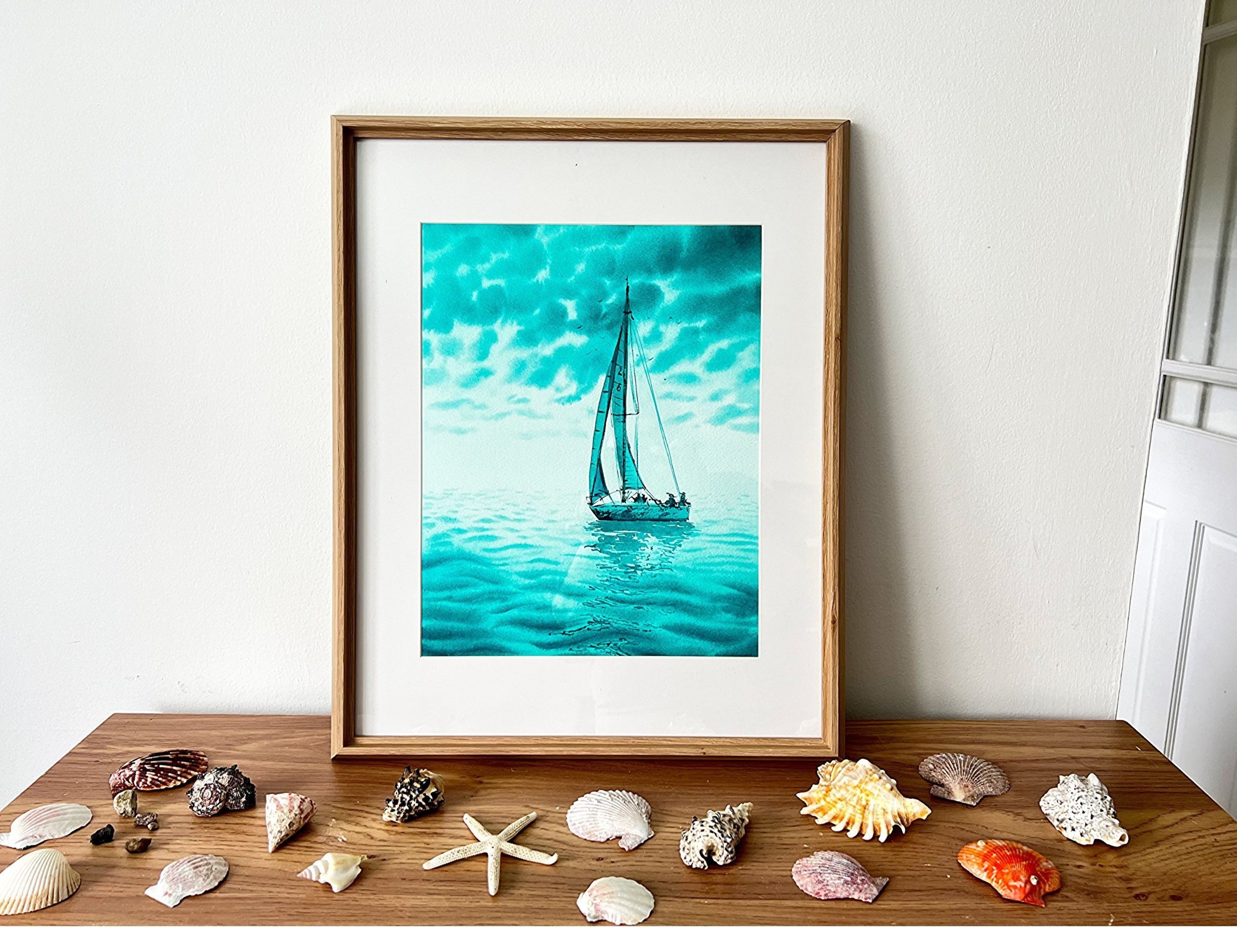 Monochromatic turquoise watercolor of a sailing yacht in the open sea. "Turquoise Green" evokes adventure and freedom with dynamic brushstrokes and vibrant hues. On a shelf with shells.