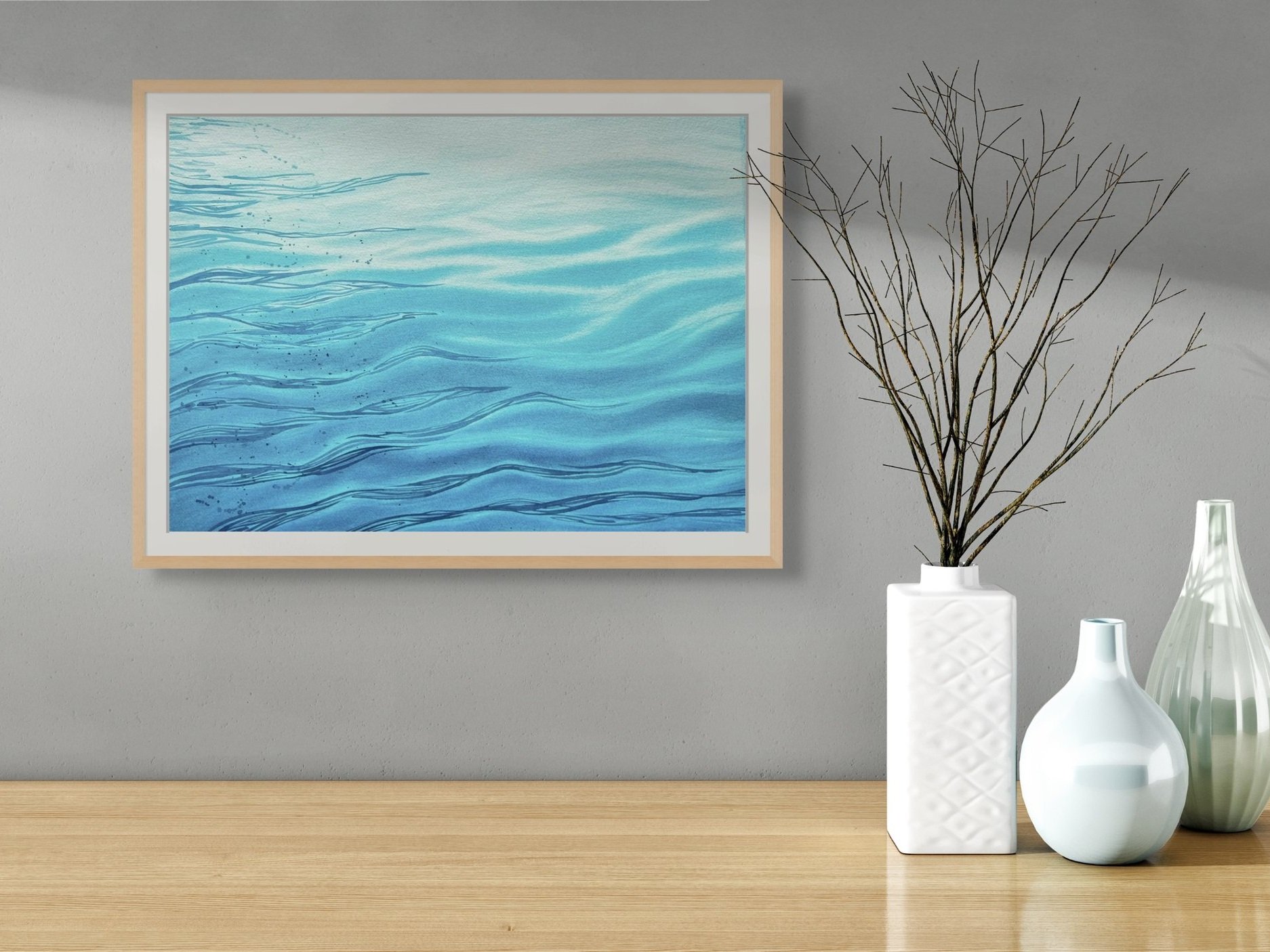 Original watercolor painting "Still Waters" framed and staged in a living room or hallway, adding a calming, serene touch with its gentle wave patterns.
