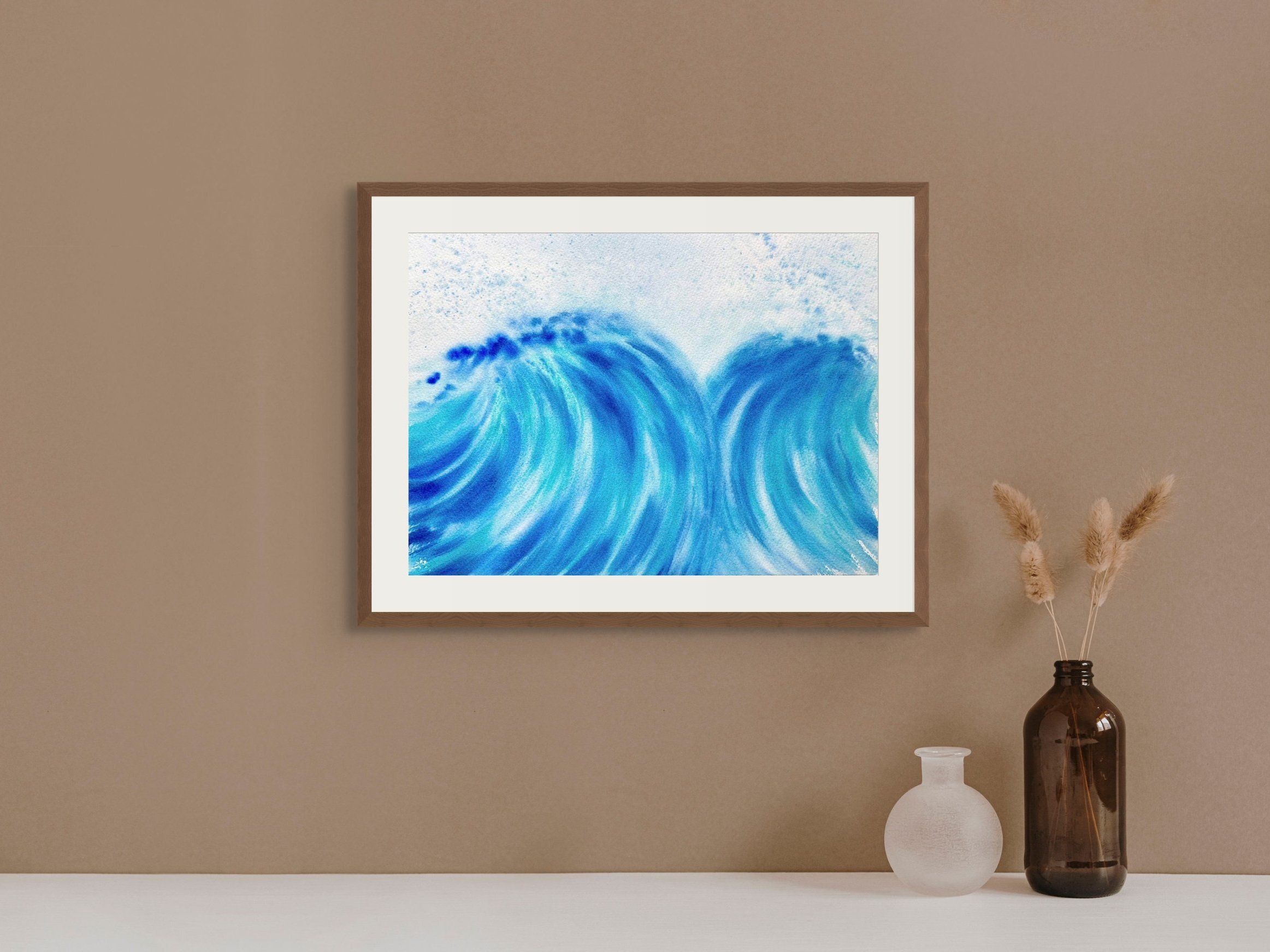 The vibrant watercolor painting "A Dance for Two" featuring dynamic crashing waves framed on a shelf. Perfect for modern coastal decor.