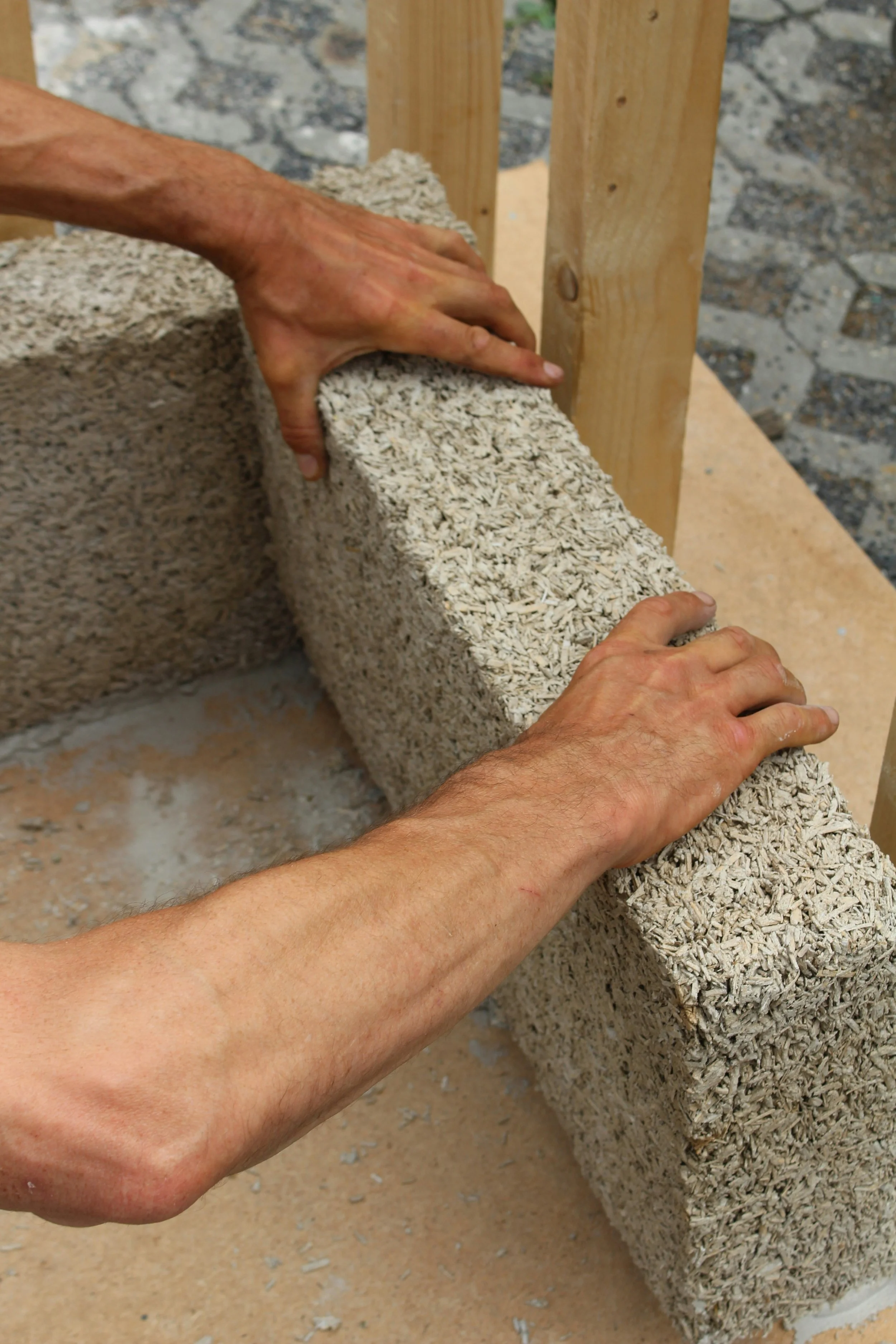 forearms of a man building a wall