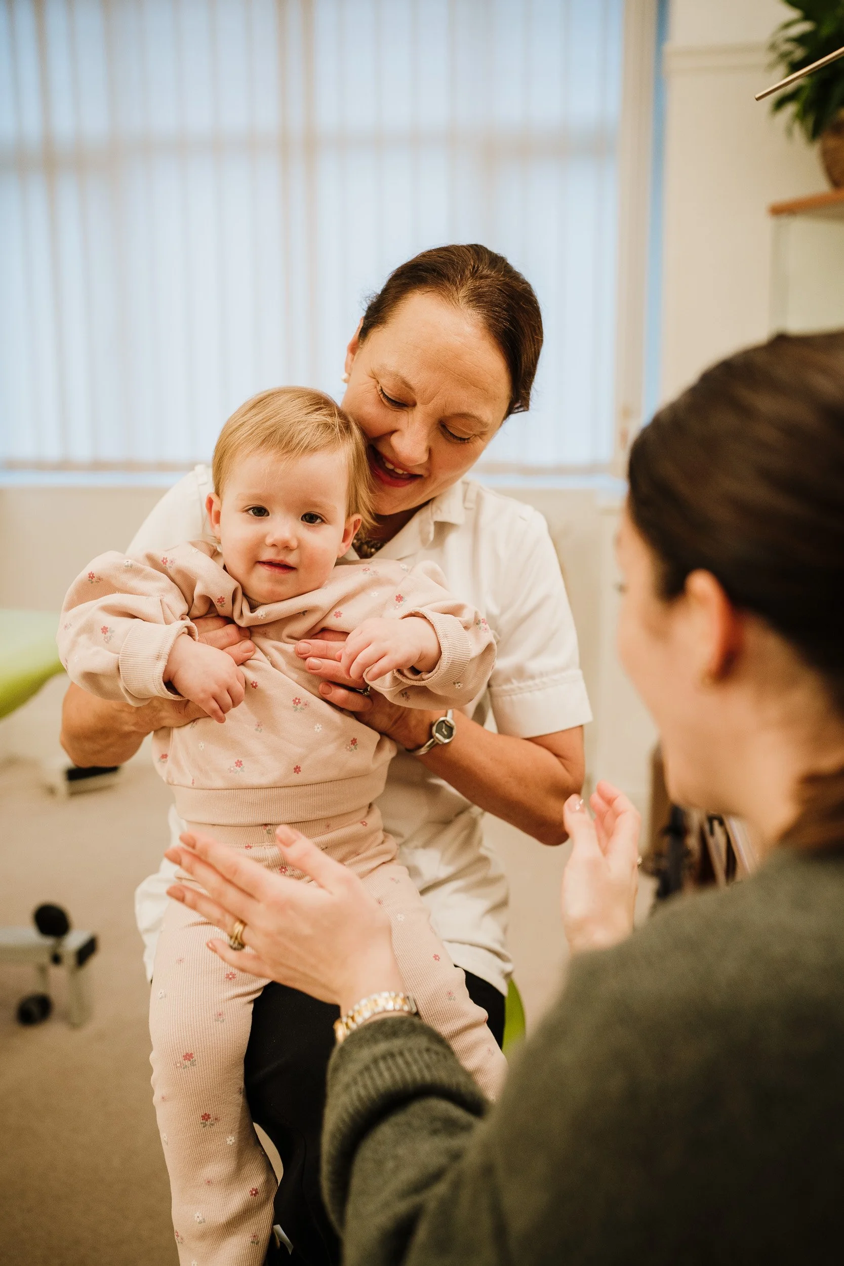 Osteopath treating child with cranial osteopathy