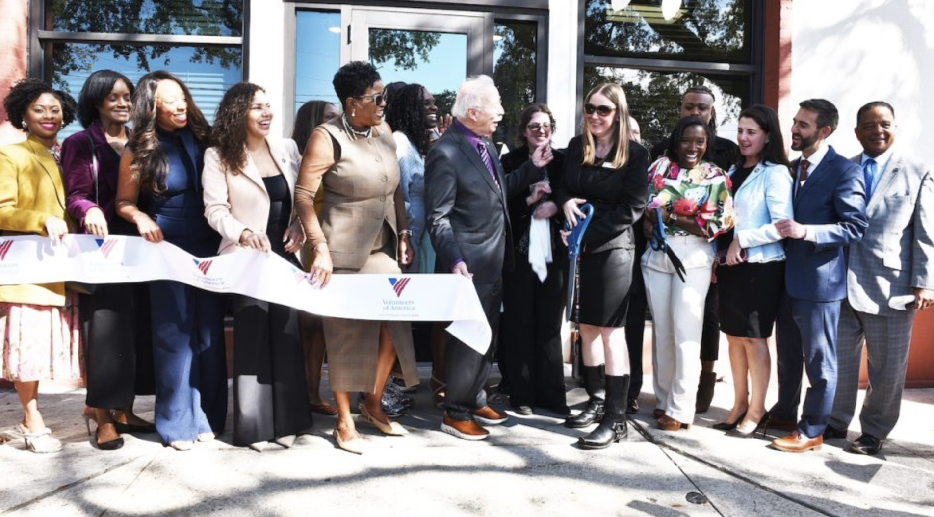 A diverse group cuts a ribbon to celebrate the opening of the Canal Pointe Family Focused Recovery Center in New Orleans