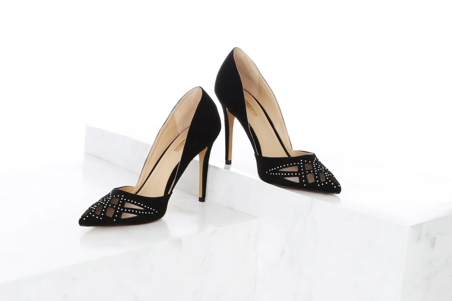 Pair of high heel shoes places on marble steps