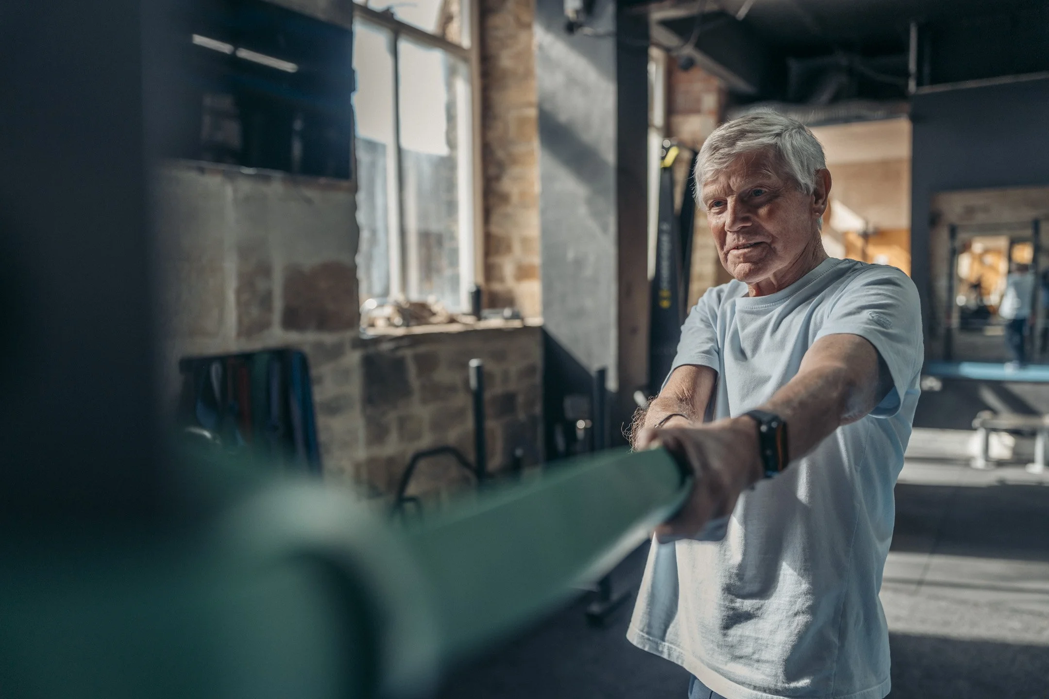 Elder man working out in the gym