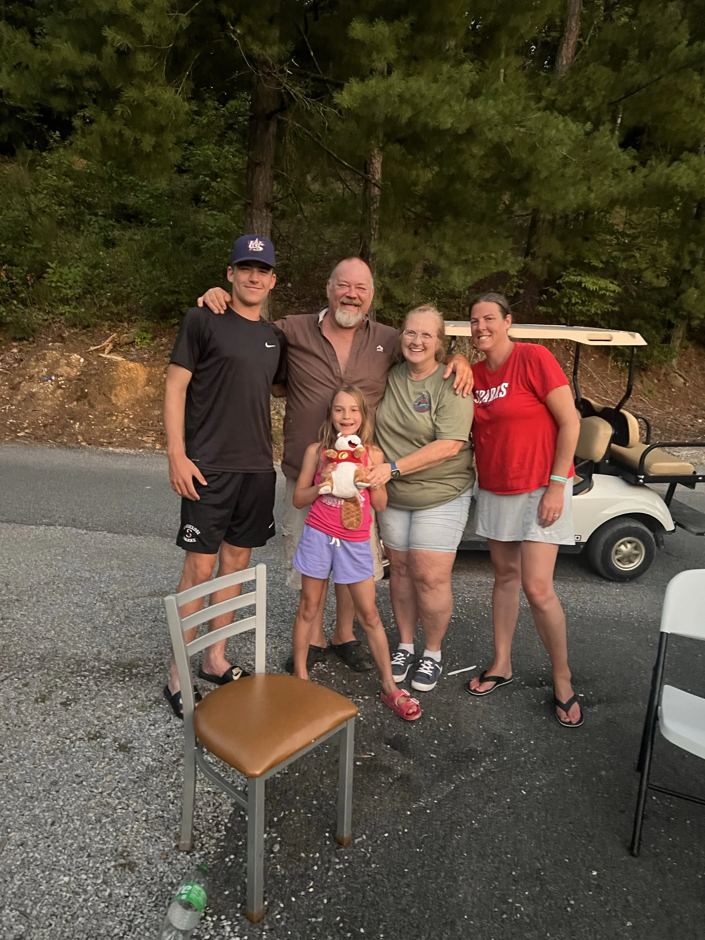 A family relaxing and having fun together at Holiday Hills Resort, surrounded by nature and resort amenities.