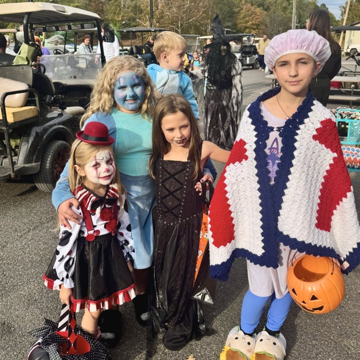 Children dressed in creative Halloween costumes enjoying the spooky festivities at Holiday Hills Resort.