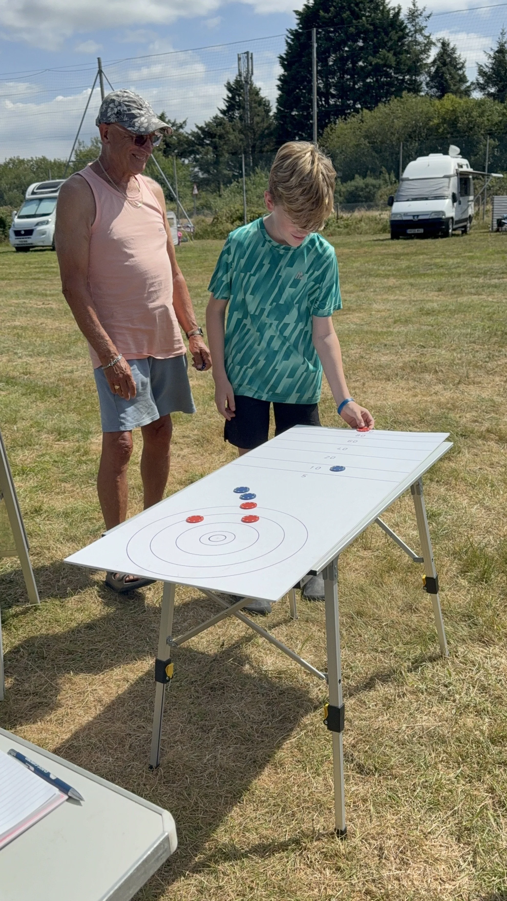 Sandra Wright Grandad with Grandson having a competitive game of Curling  (1).jpeg