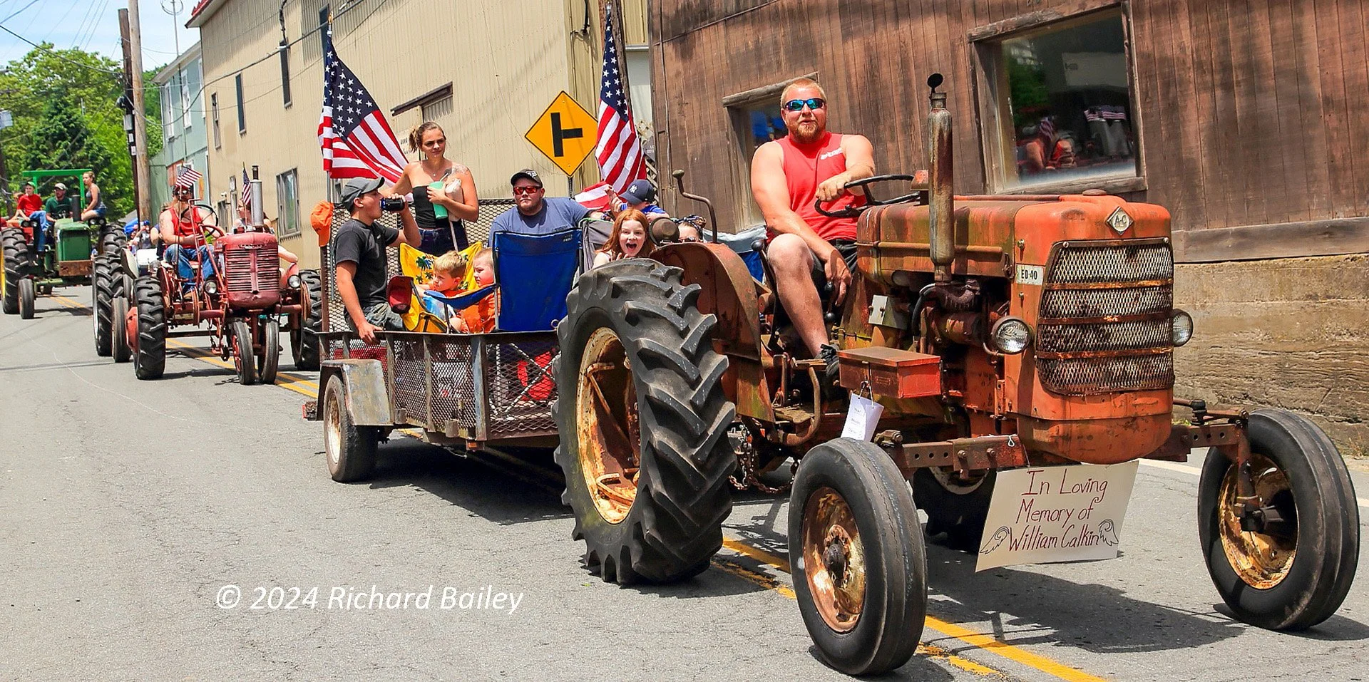 Vintage tractors roll through the village of Callicoon, New York during the annual tractor parade in the Catskill Mountains.