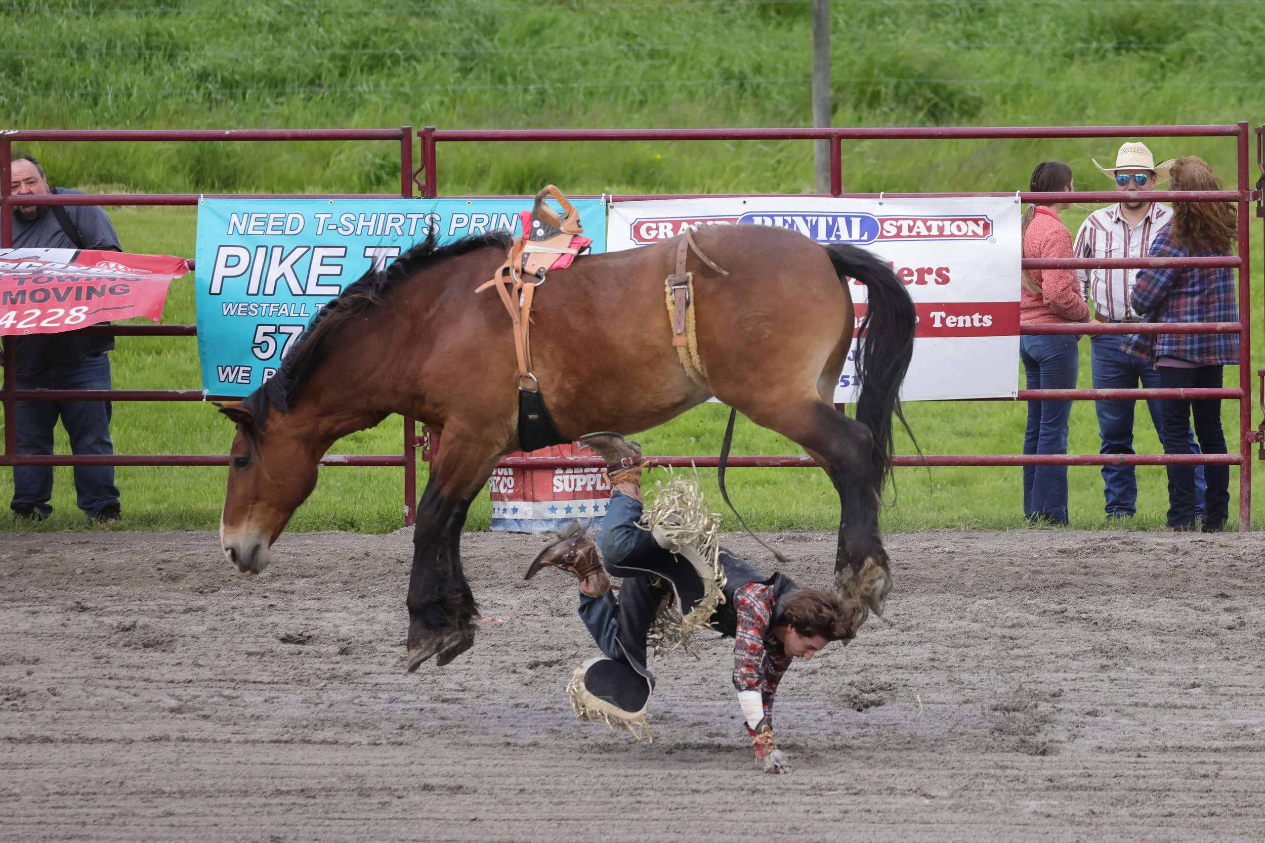A rider hits the ground as a bucking horse leaps over him at the Green Valley Farms Rodeo in Sussex, New Jersey.