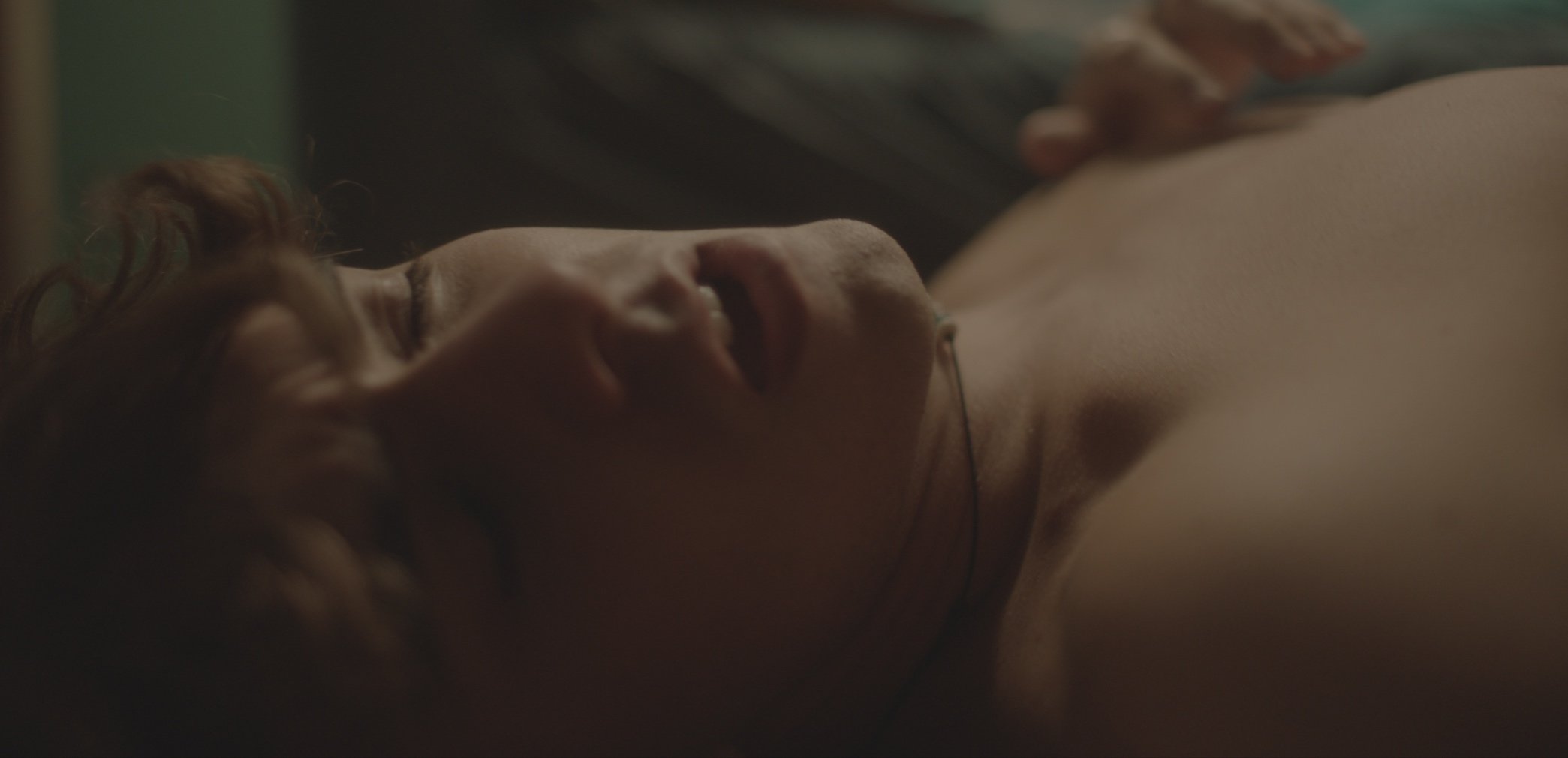 Close-up of a person lying down with eyes closed.