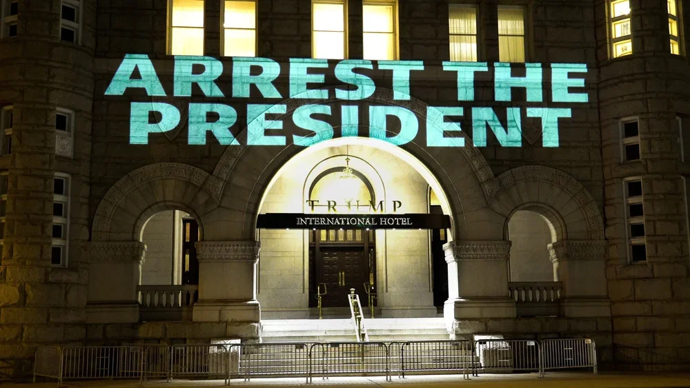 01.+Robin+Bell+projects+onto+the+Trump+Hotel,+Arrest+the+president,+Jan+12+2021,+1920 × 1080.webp