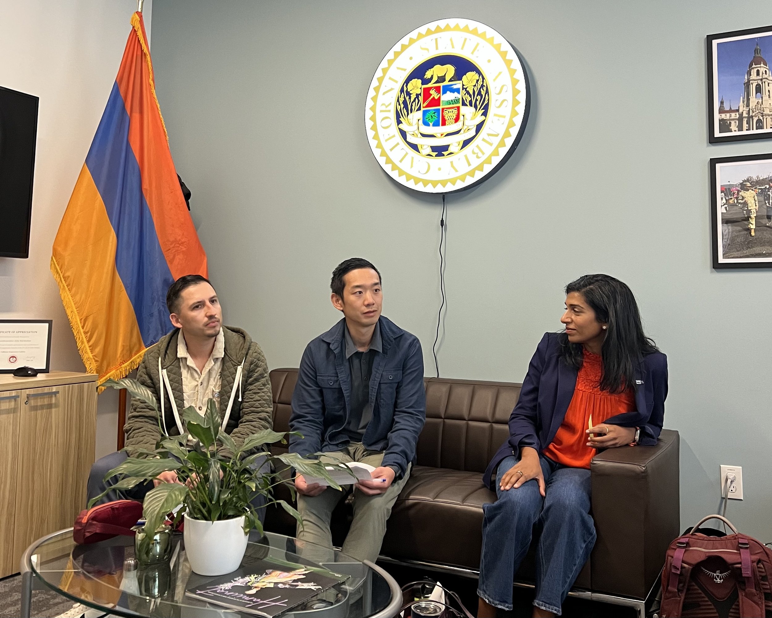 Fish On Ambassadors Steven and Austin with Founder and Executive Anupa Asokan during a legislative meeting.