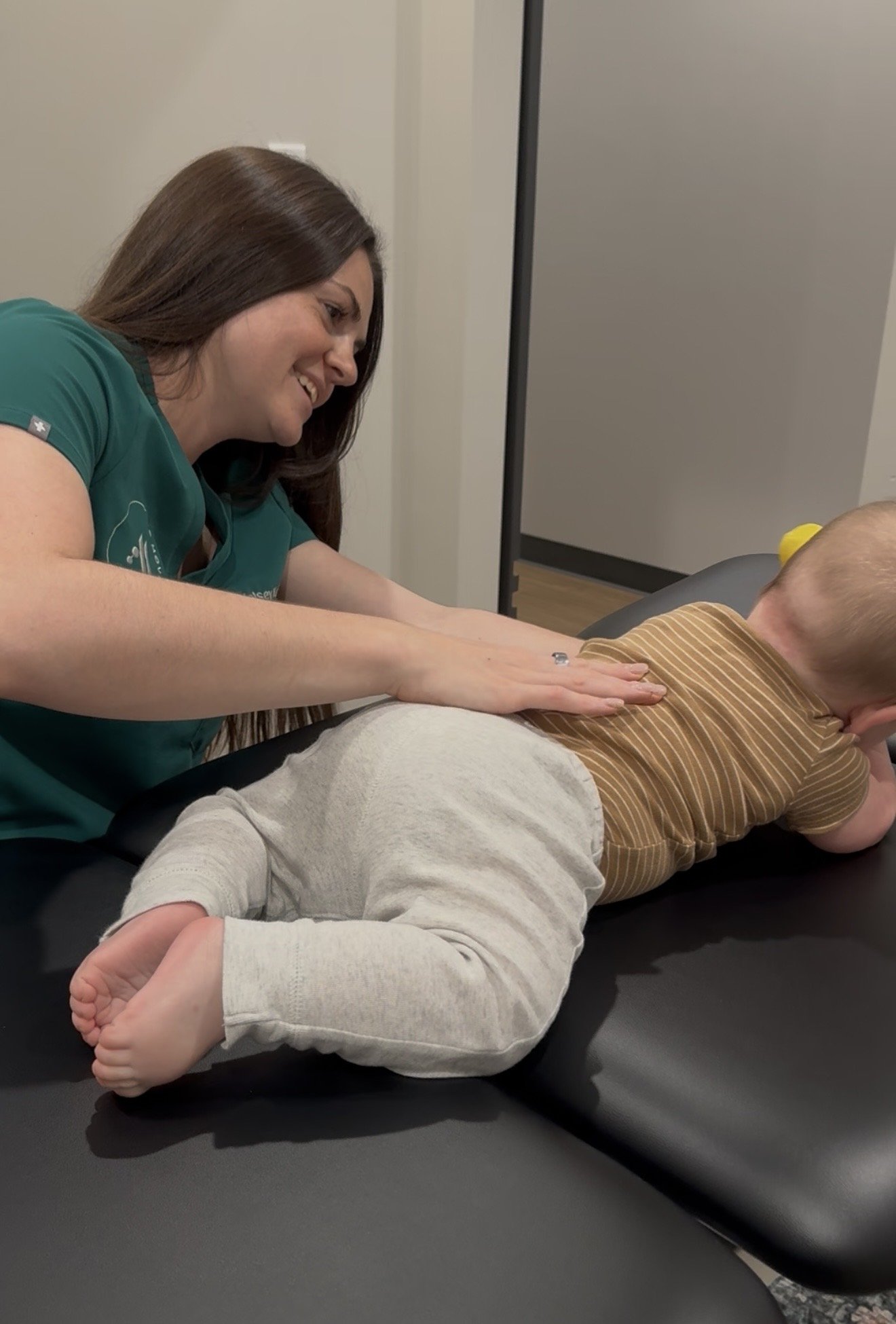Baby receiving gentle pediatric chiropractic care in a calm, supportive setting