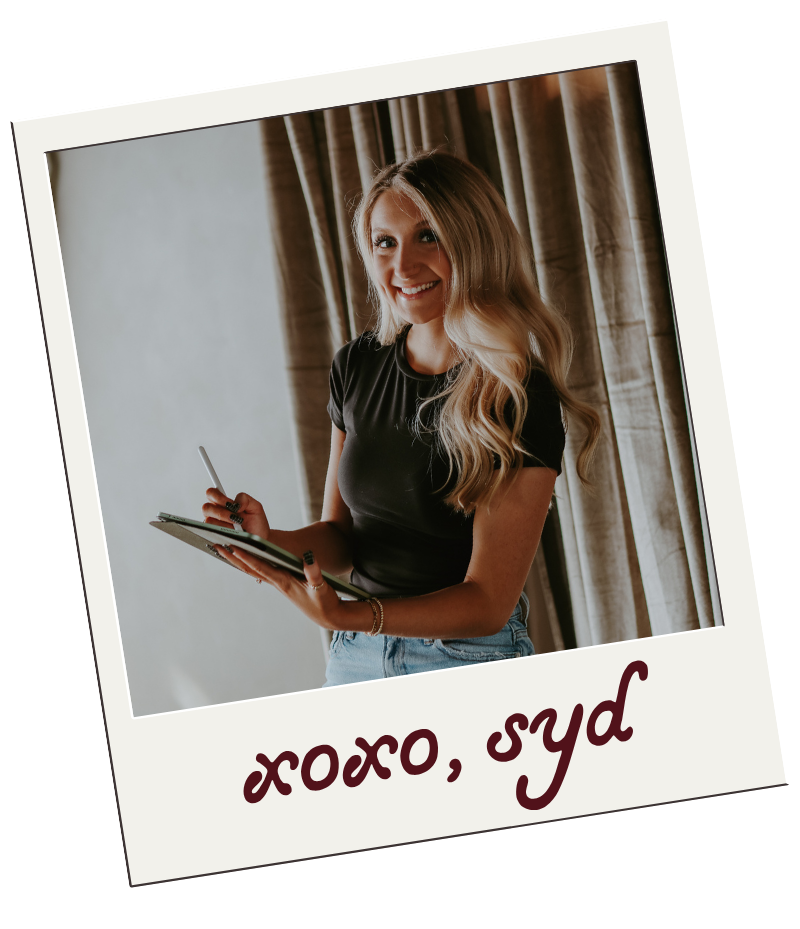 Sydney, designer behind StudioSyd, holding a tablet and stylus.
