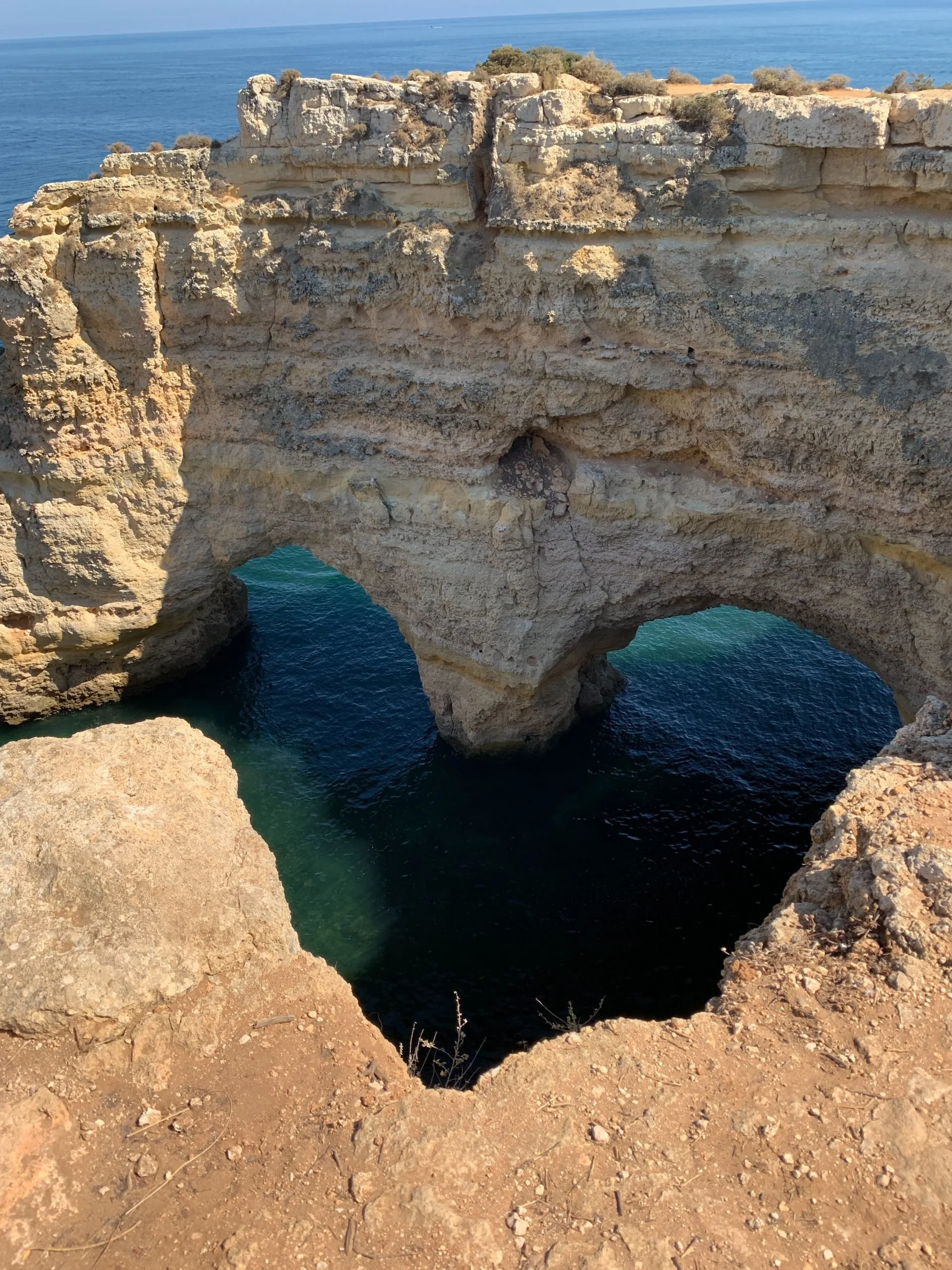 Photo of limestone cliffs and ocean in Portugal forming a heart shape