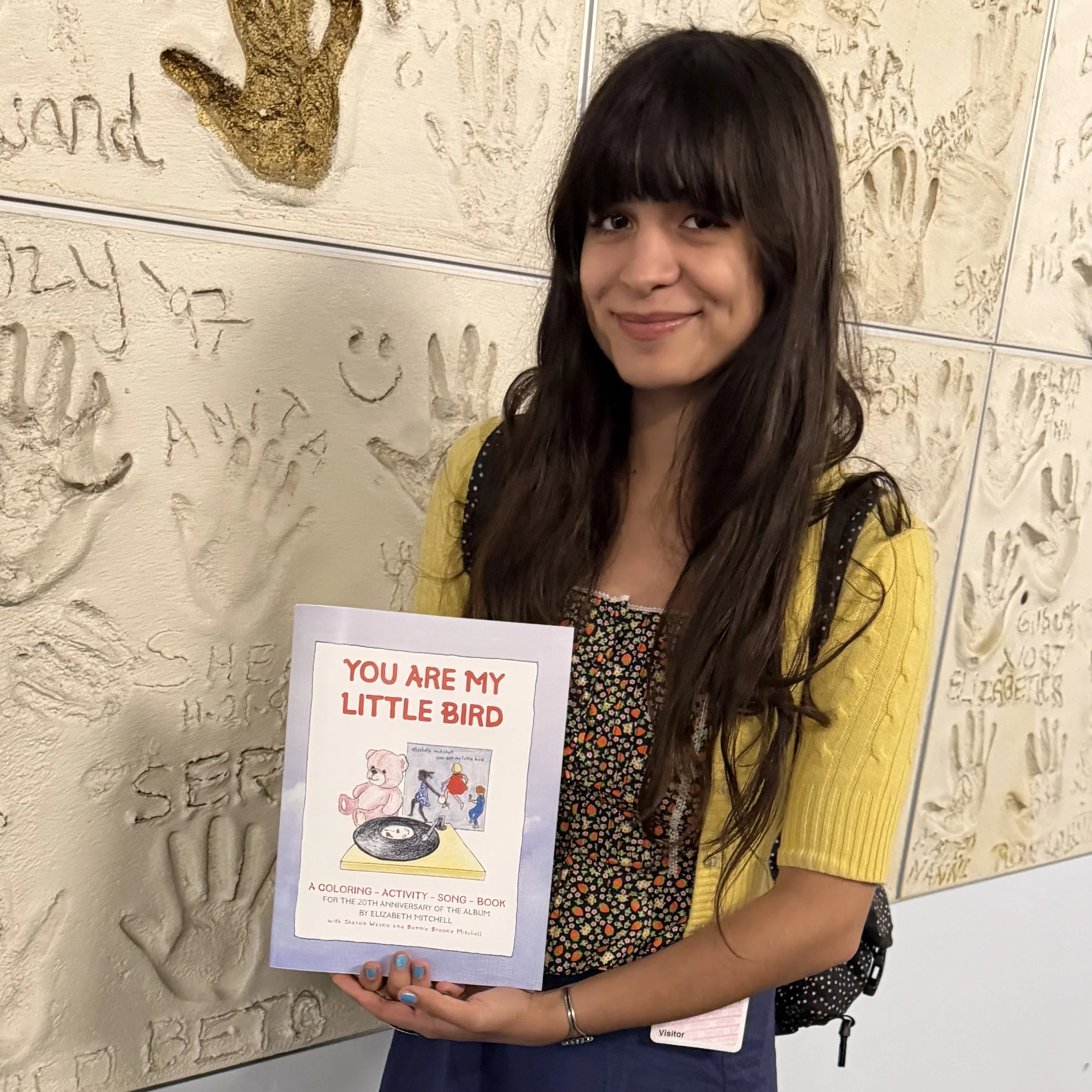 Storey Littleton holding You Are My Little Bird Coloring, Activity, and Songbook
