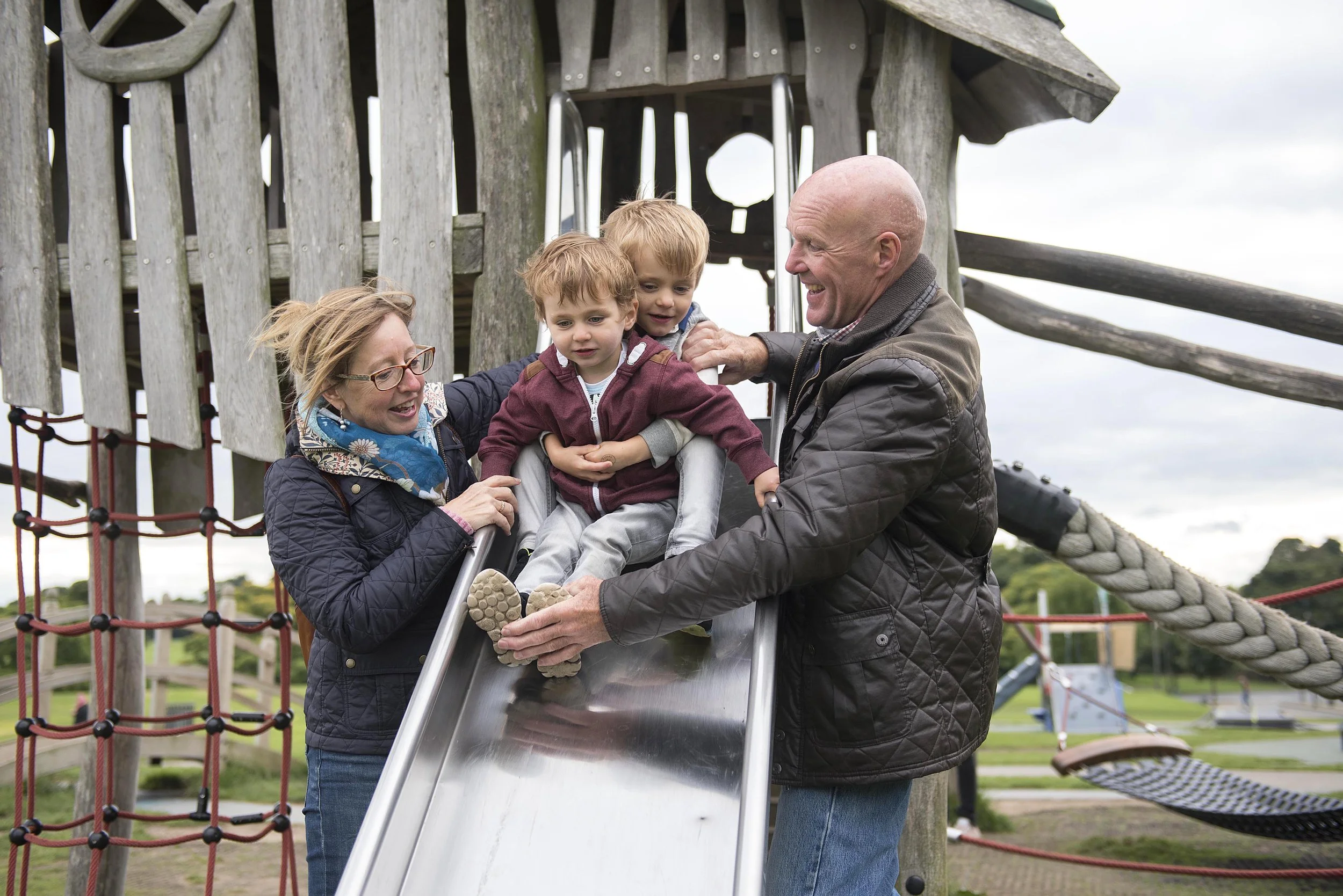 grandparents-playing-with-children-on-the-slide.jpg