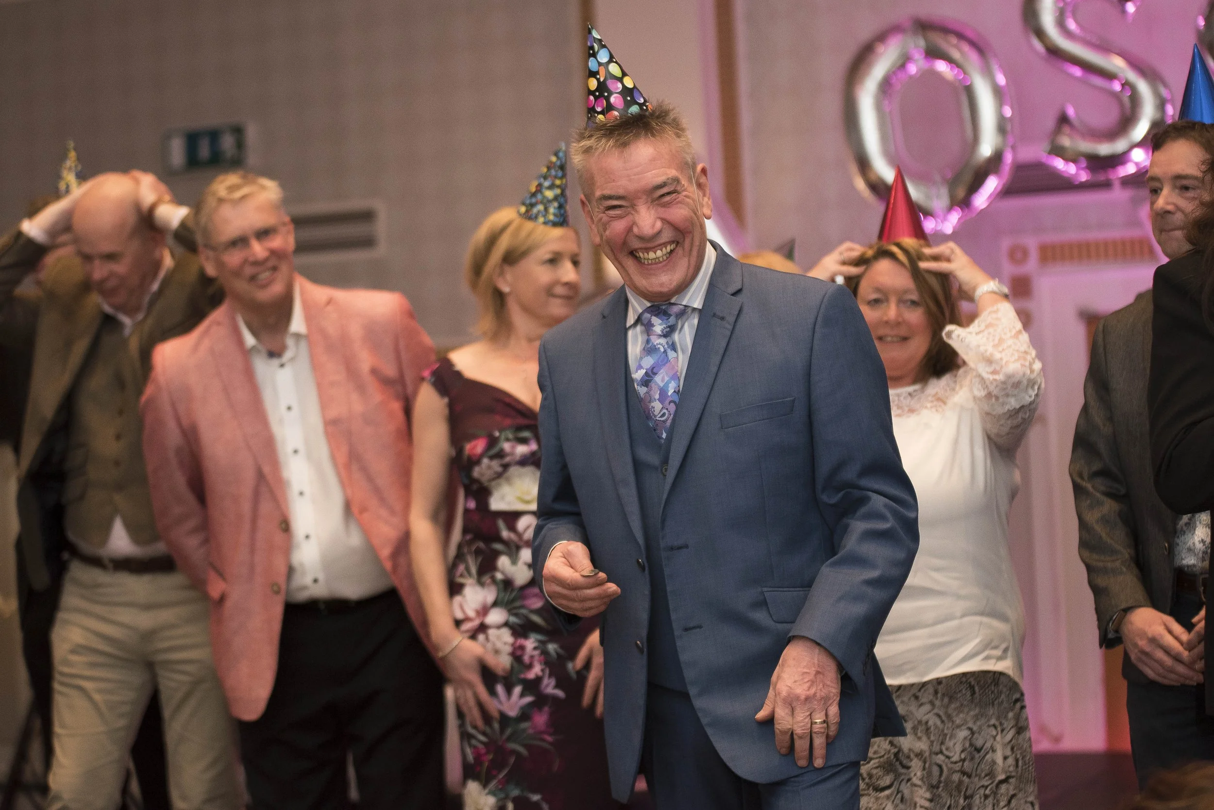 charity ball presenter wearing a party hat and silly grin. Breast Cancer Haven Leeds