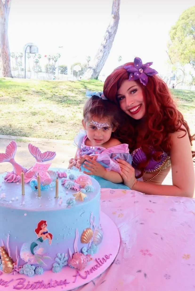 The Little Mermaid hugging a young girl at her Birthday Party celebration in LA.