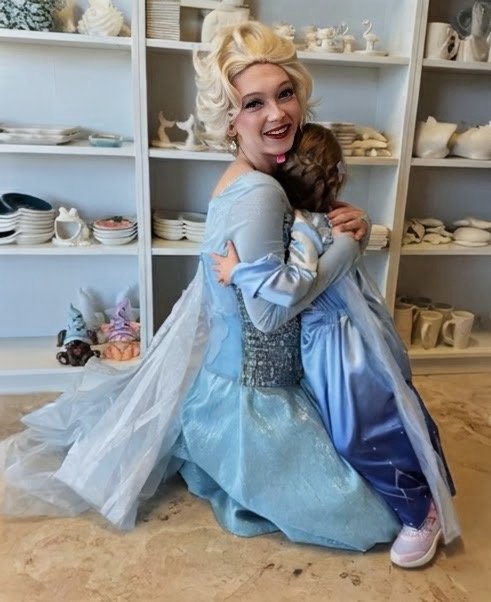 Ice Queen hugging a little girl.png