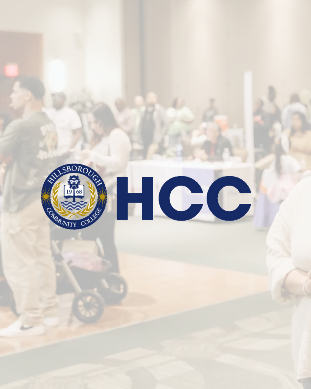 A blurred indoor event with numerous people, some standing and others sitting, and a table with a white tablecloth. In the foreground, there is a logo of Hillsborough Community College and the letters 'HCC' in large blue font.