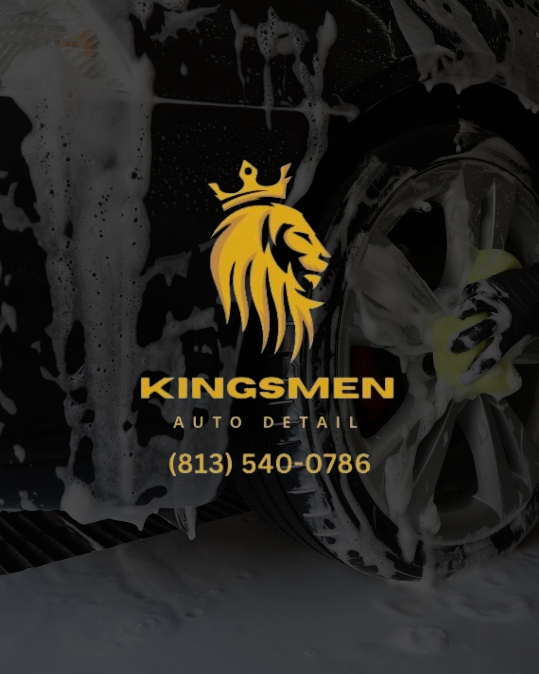 Business card for Kingsmen Auto Detail with a gold lion logo and contact phone number, water with soap suds and a wheel in the background.