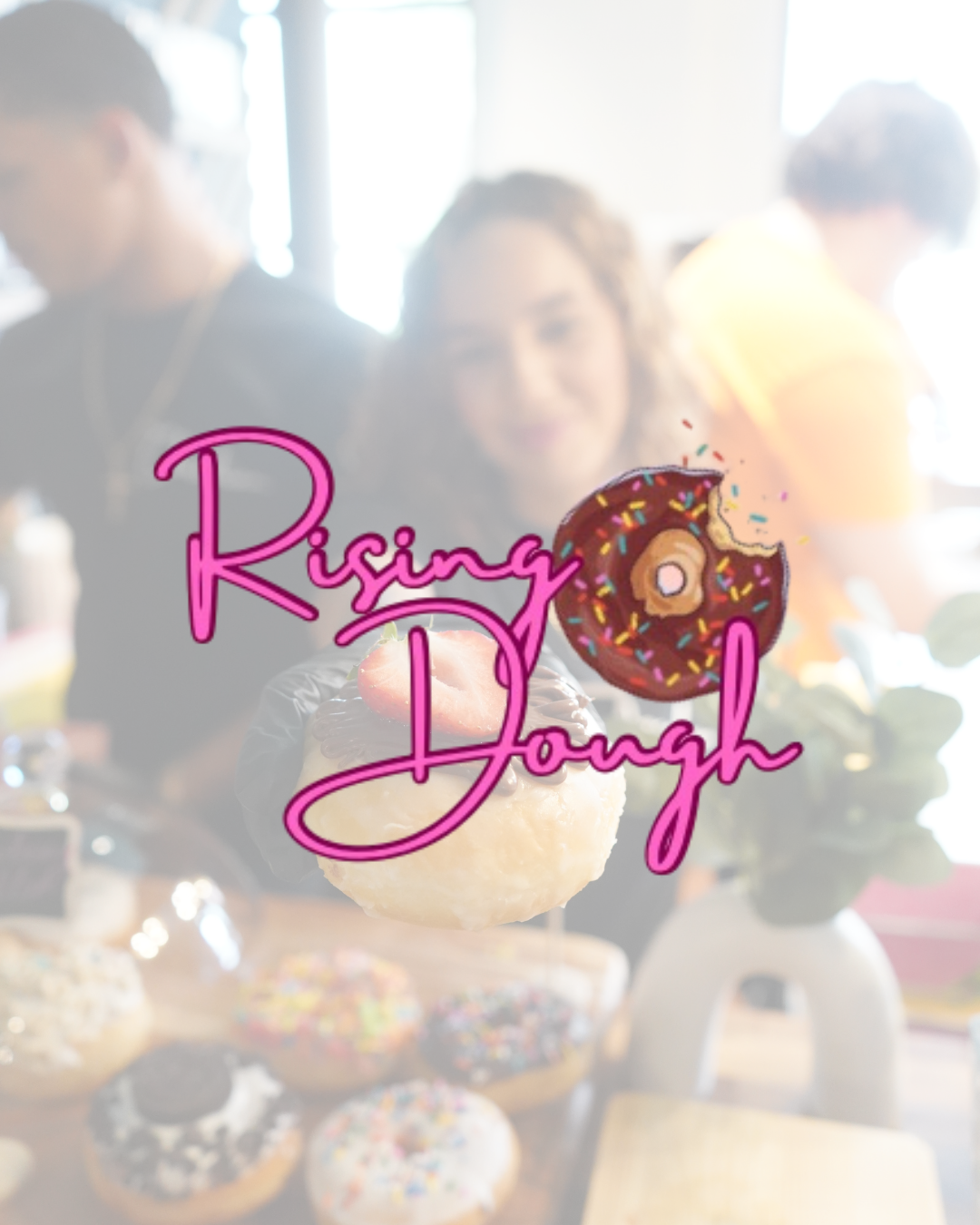 People eating donuts at a cafe with a sign that says "Rising Dough" featuring a pink neon-style donut with sprinkles.