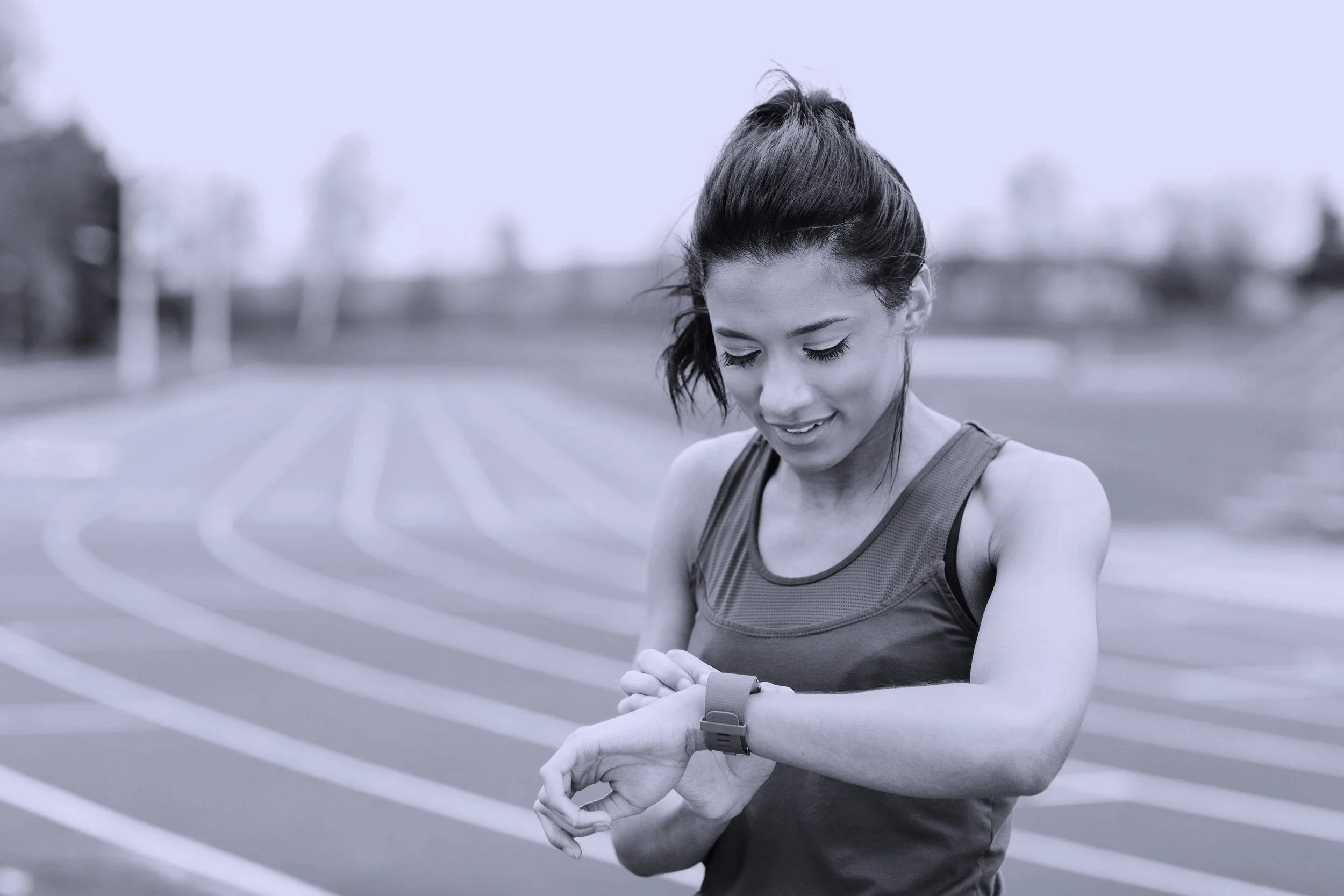 young-woman-on-running-track-checking-watch-2021-11-09-23-41-11-utc.jpg