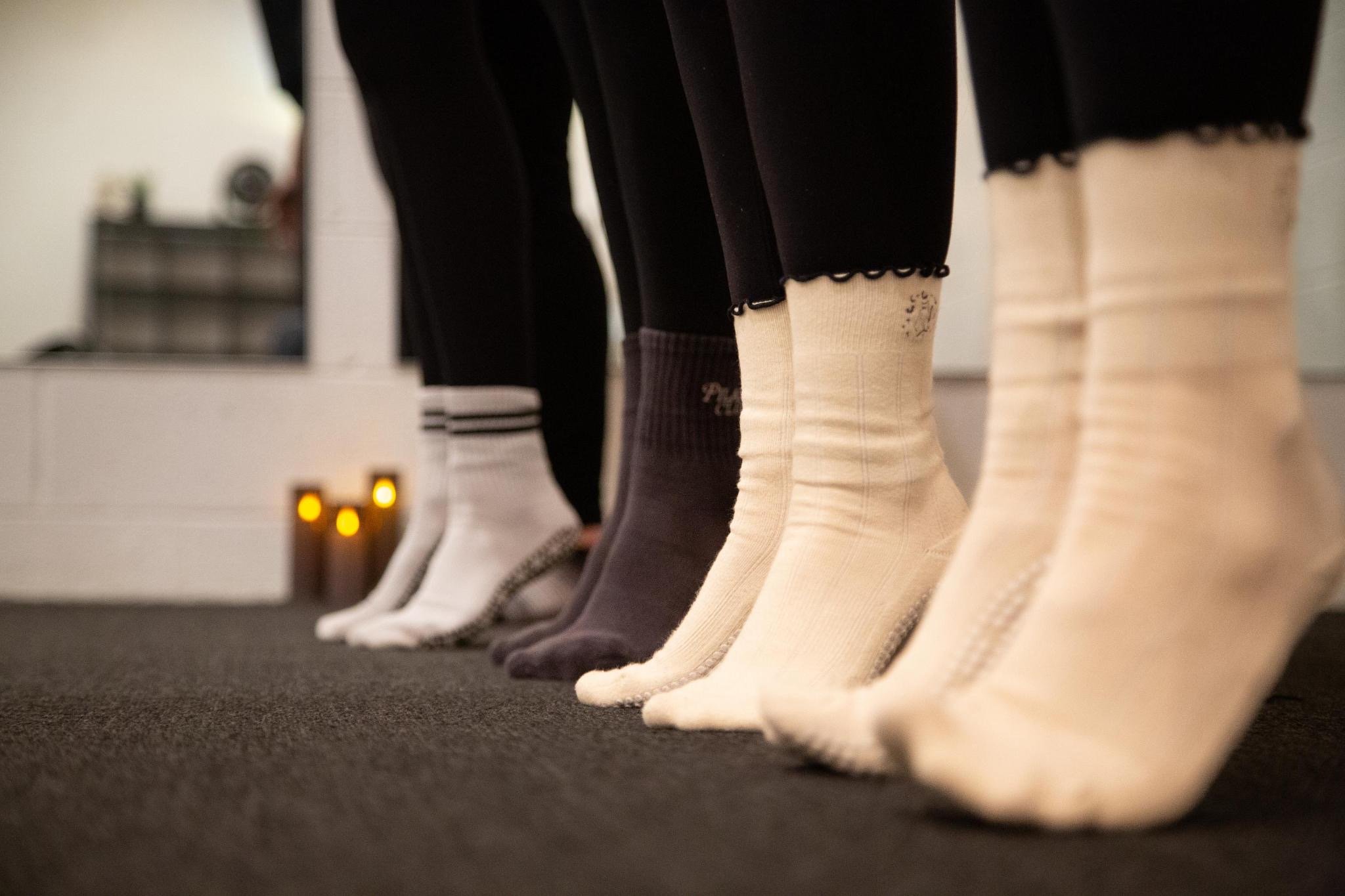 photo of clients in a line from the knee down wearing grip socks