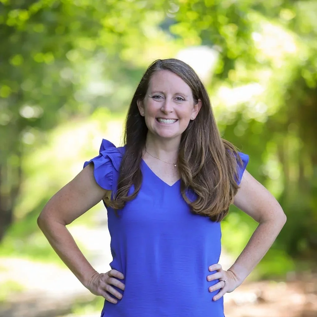 Photo of white woman with brown hair wearing a blue shirt