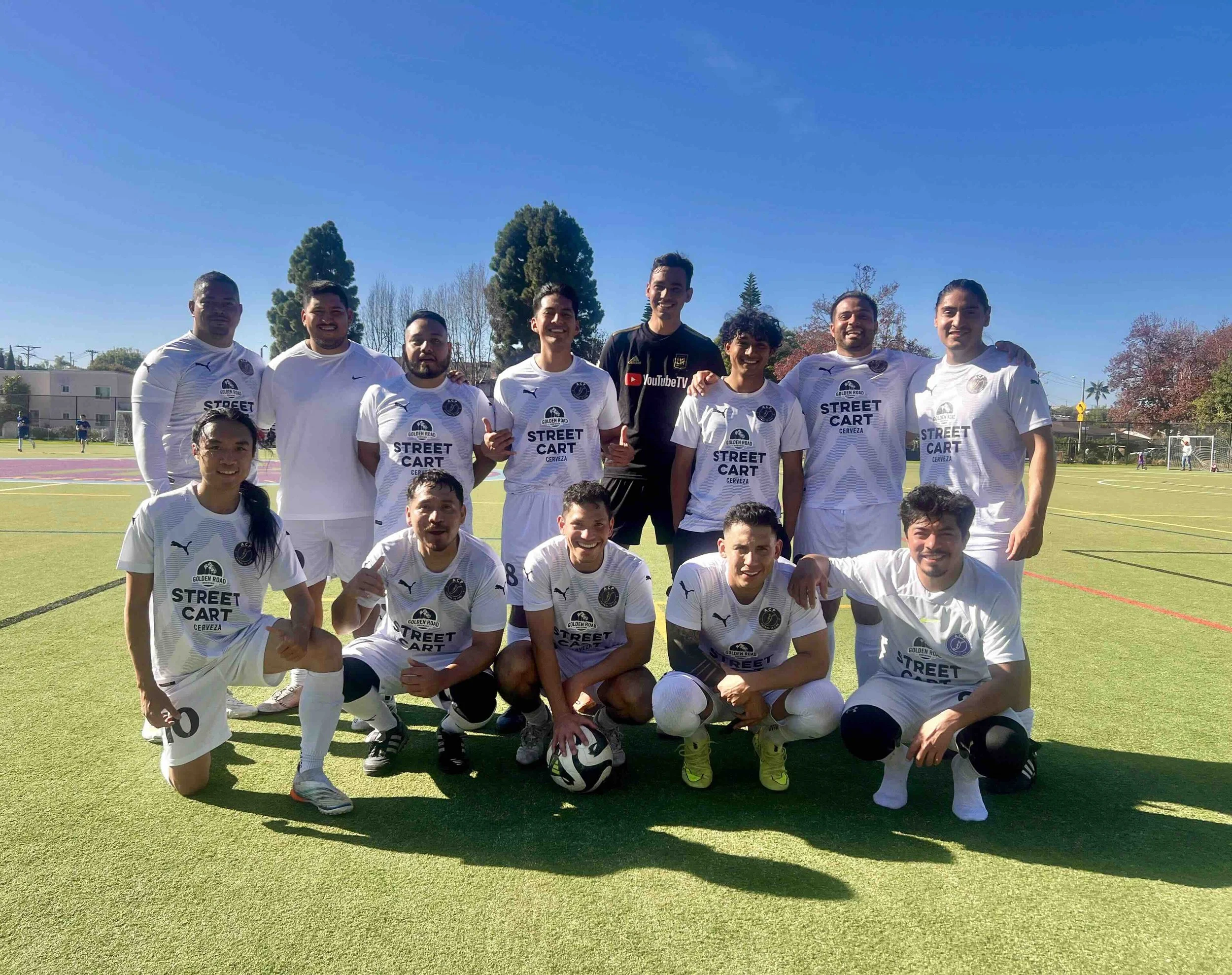 A circular navy blue and gold logo of ACAP with a stylized letter 'F' in the center, and the text 'ACAP', 'EST 1987', and 'FUTBOL IS LIFE' around the edges.