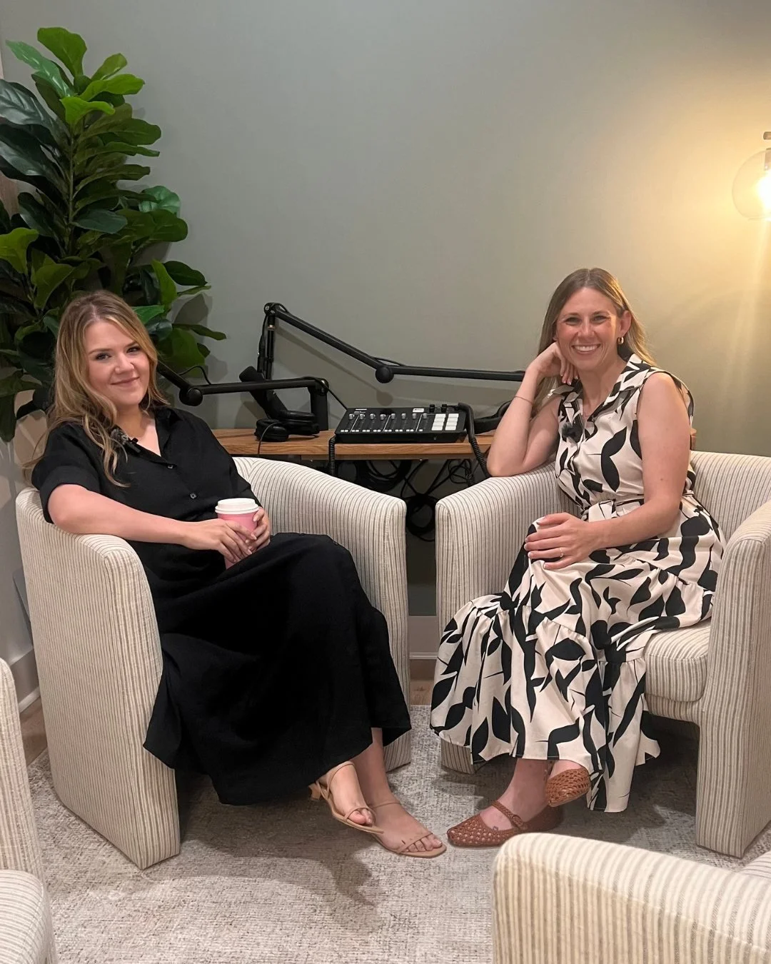 Woman in black dress and woman in beige and black floral dress hosting a podcast episode