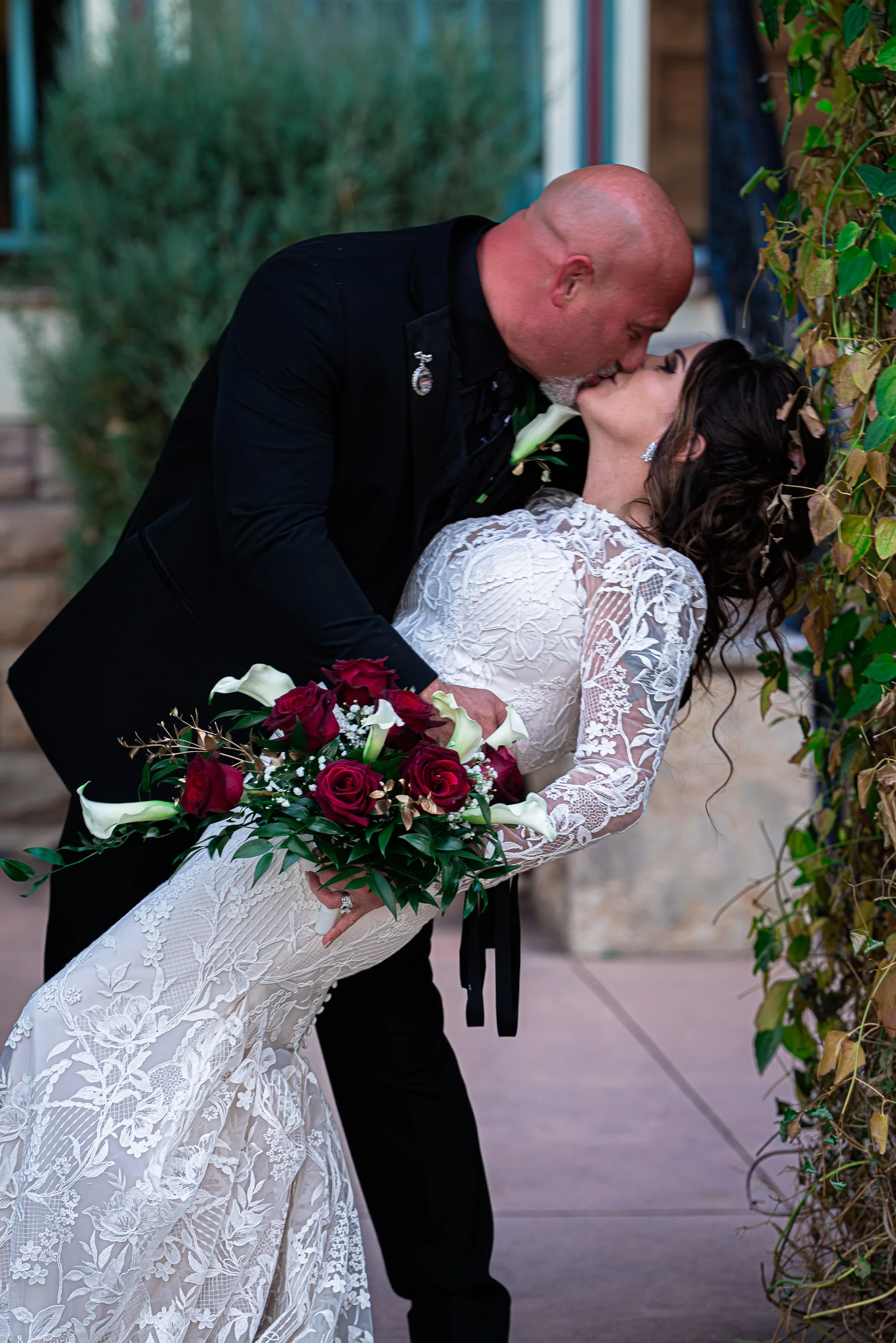 Groom dipping Bride back with a kiss