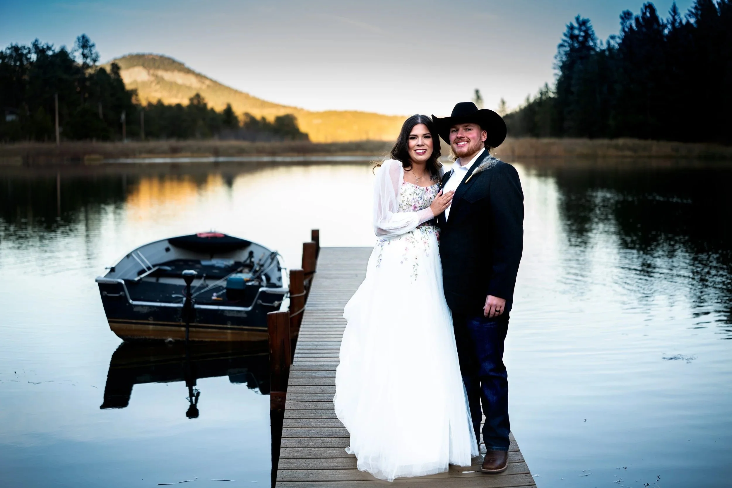 Bride and groom standing on a dock at a mountain lake during a Colorado wedding, photographed by Indie Essence Photography.