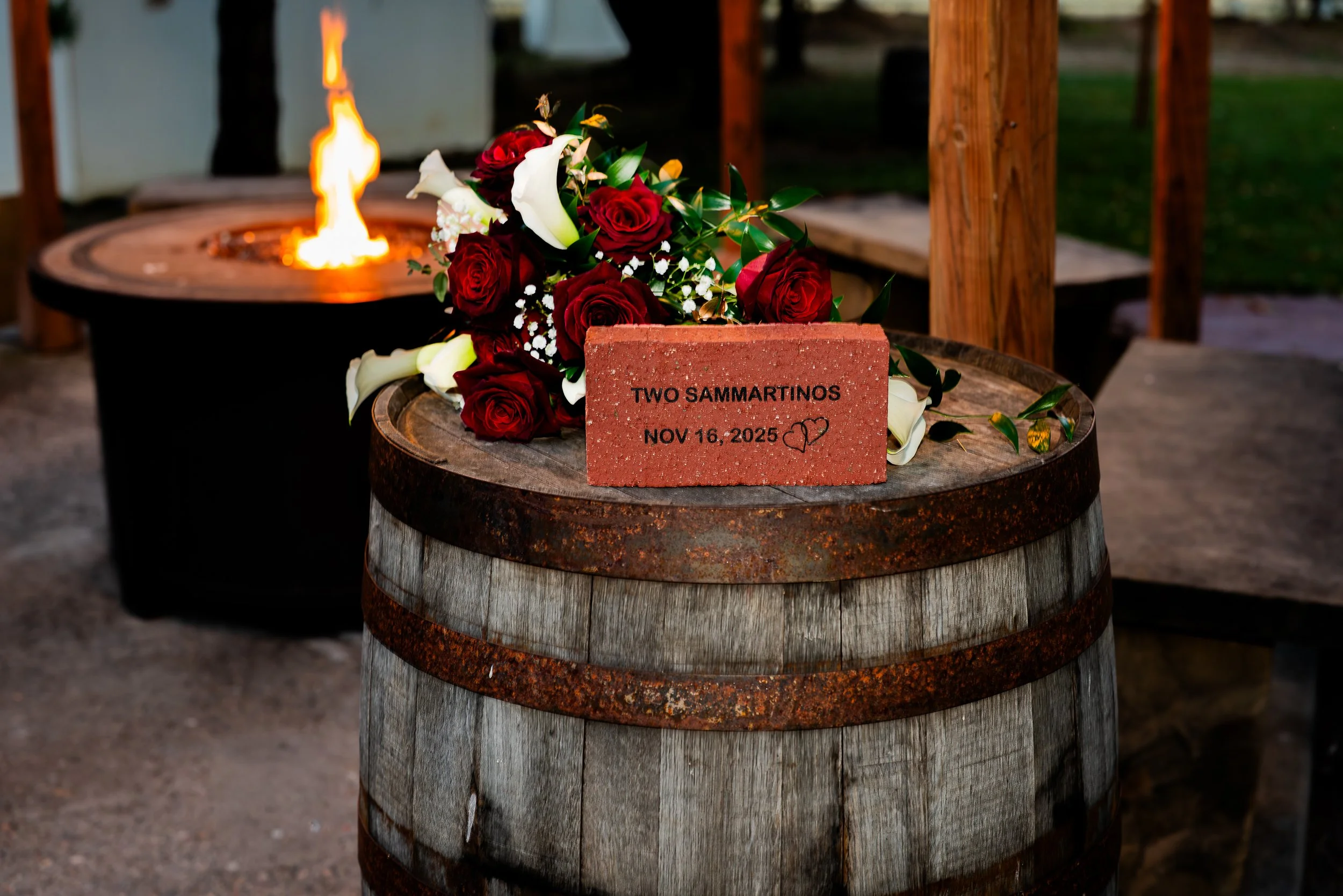 Detailed shot of Brick with Couples last name on top of a whiskey barrel in front of the fireplace. 