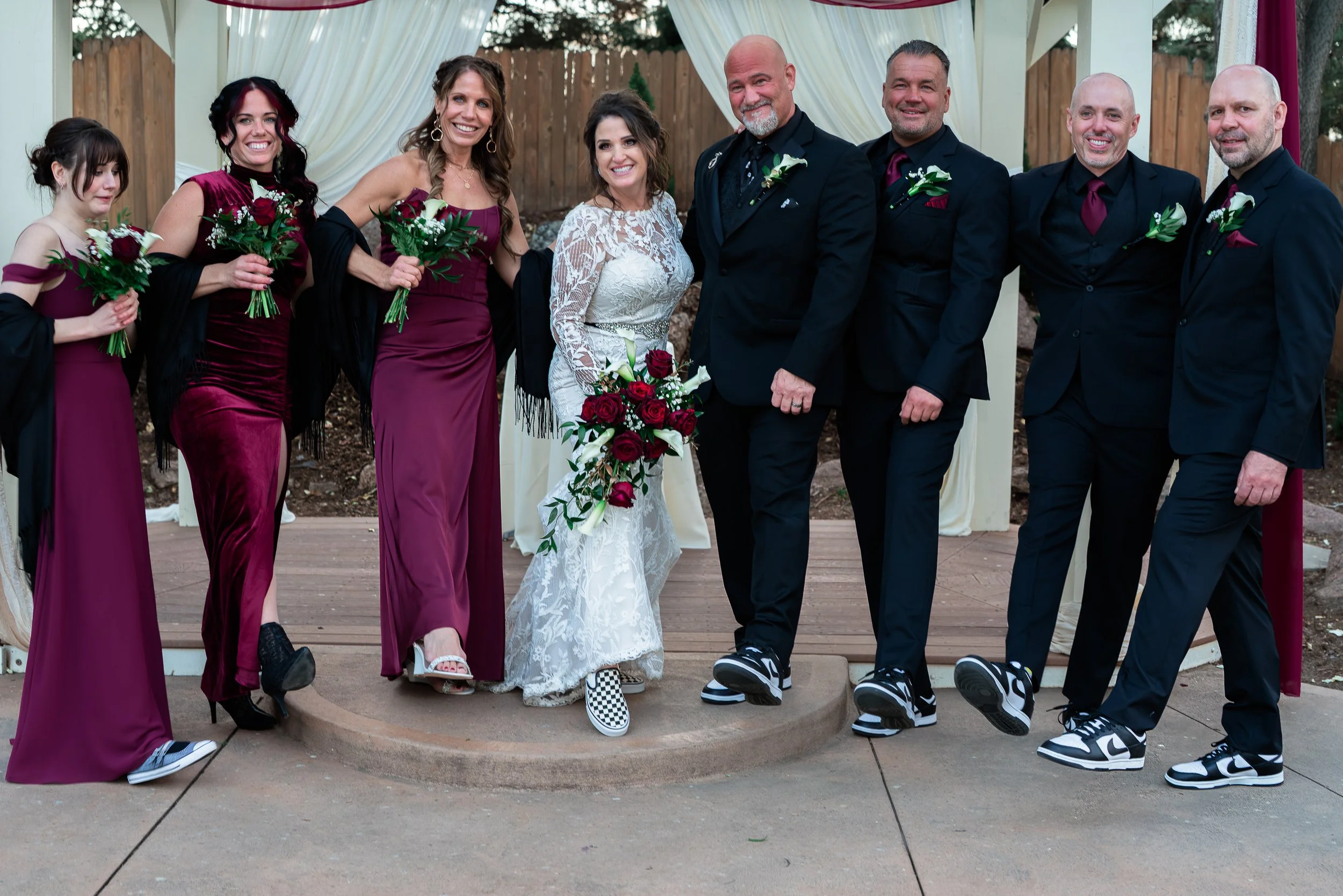 Bride, Groom, and Wedding Party showing off their shoes